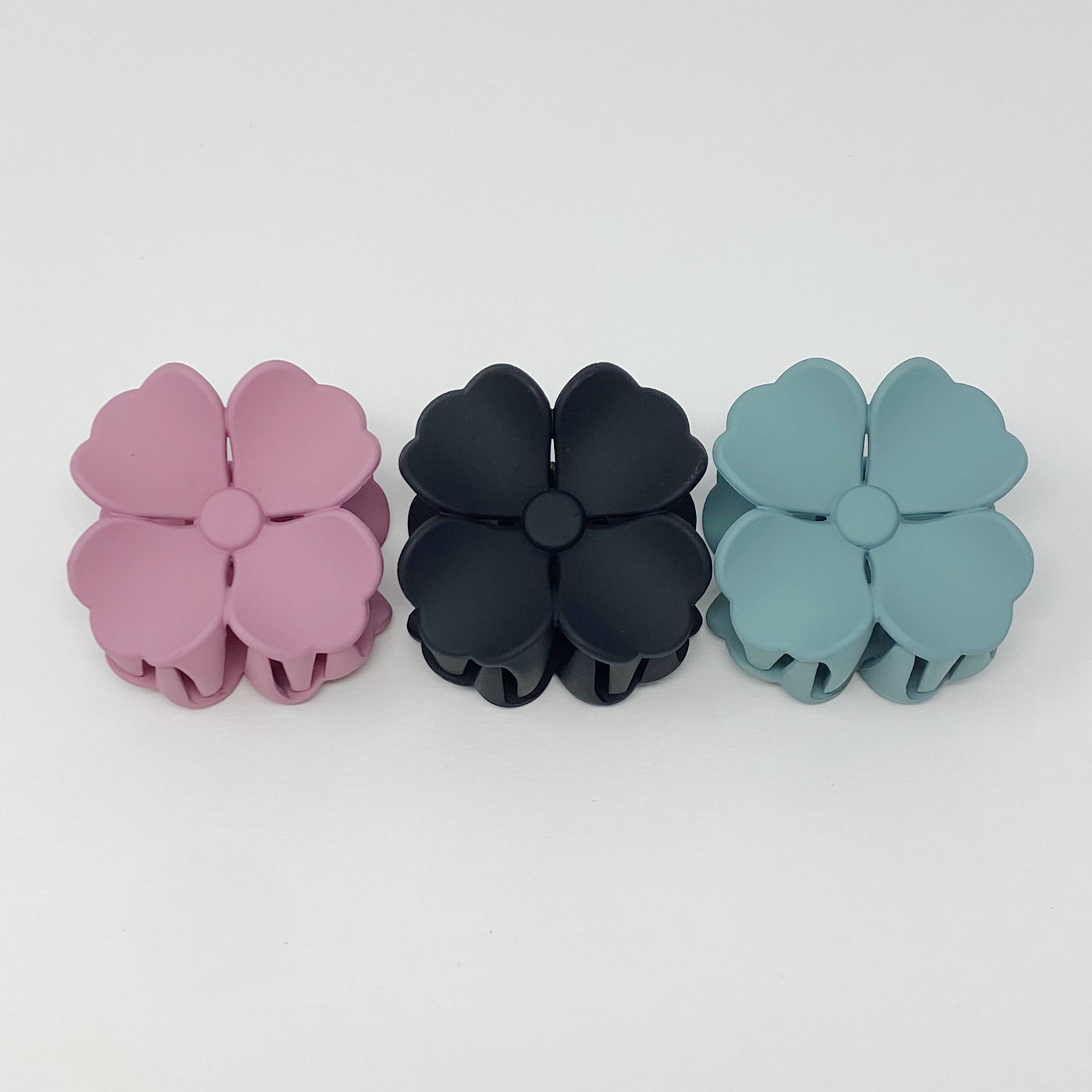 Set of 3 vibrant hibiscus flower hair claws with a matte finish, beautifully packaged in a clear cello bag.