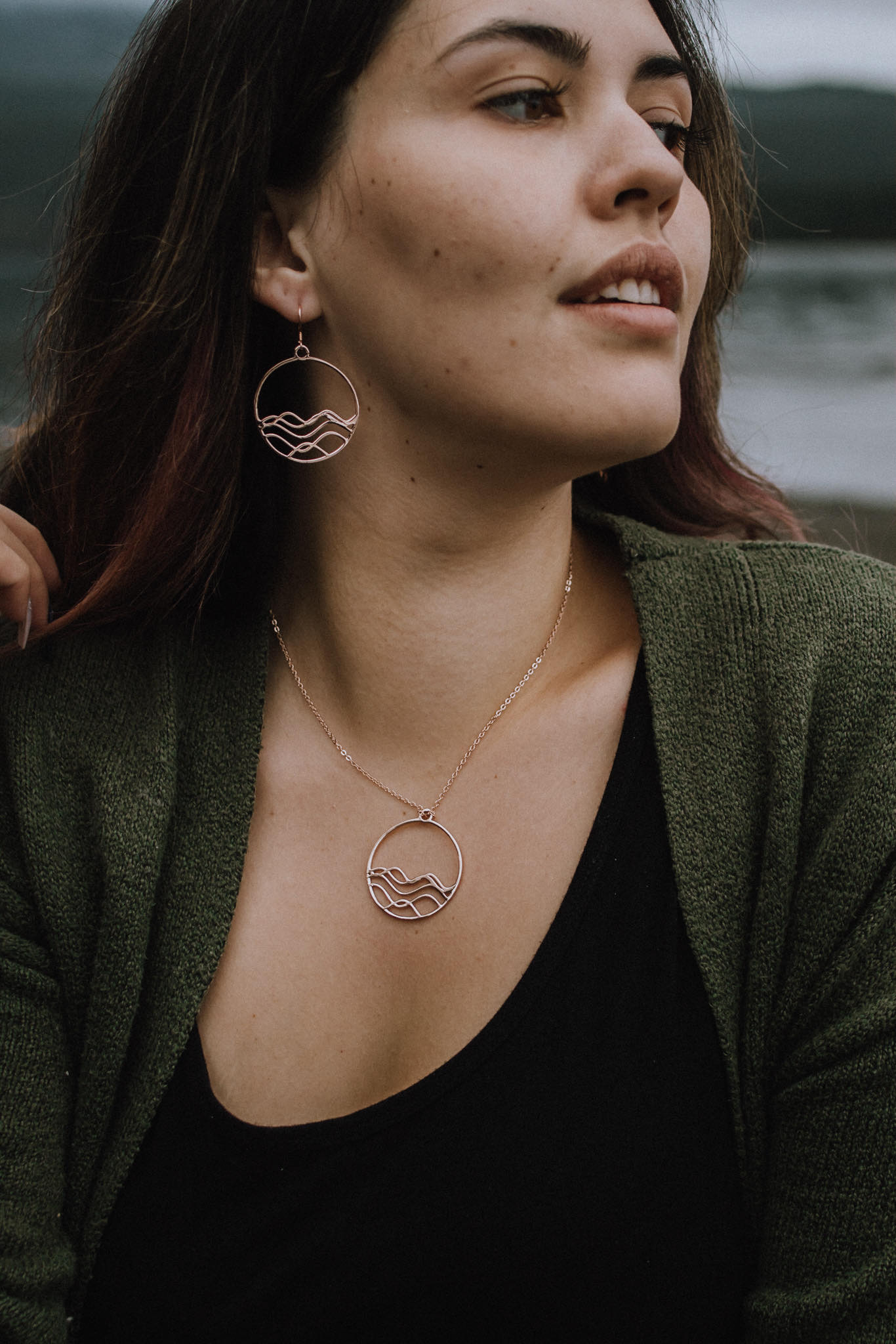 High Tide Ocean Wave Pendant in sterling silver, featuring a circular design inspired by ocean waves, displayed with a matching cable chain necklace.