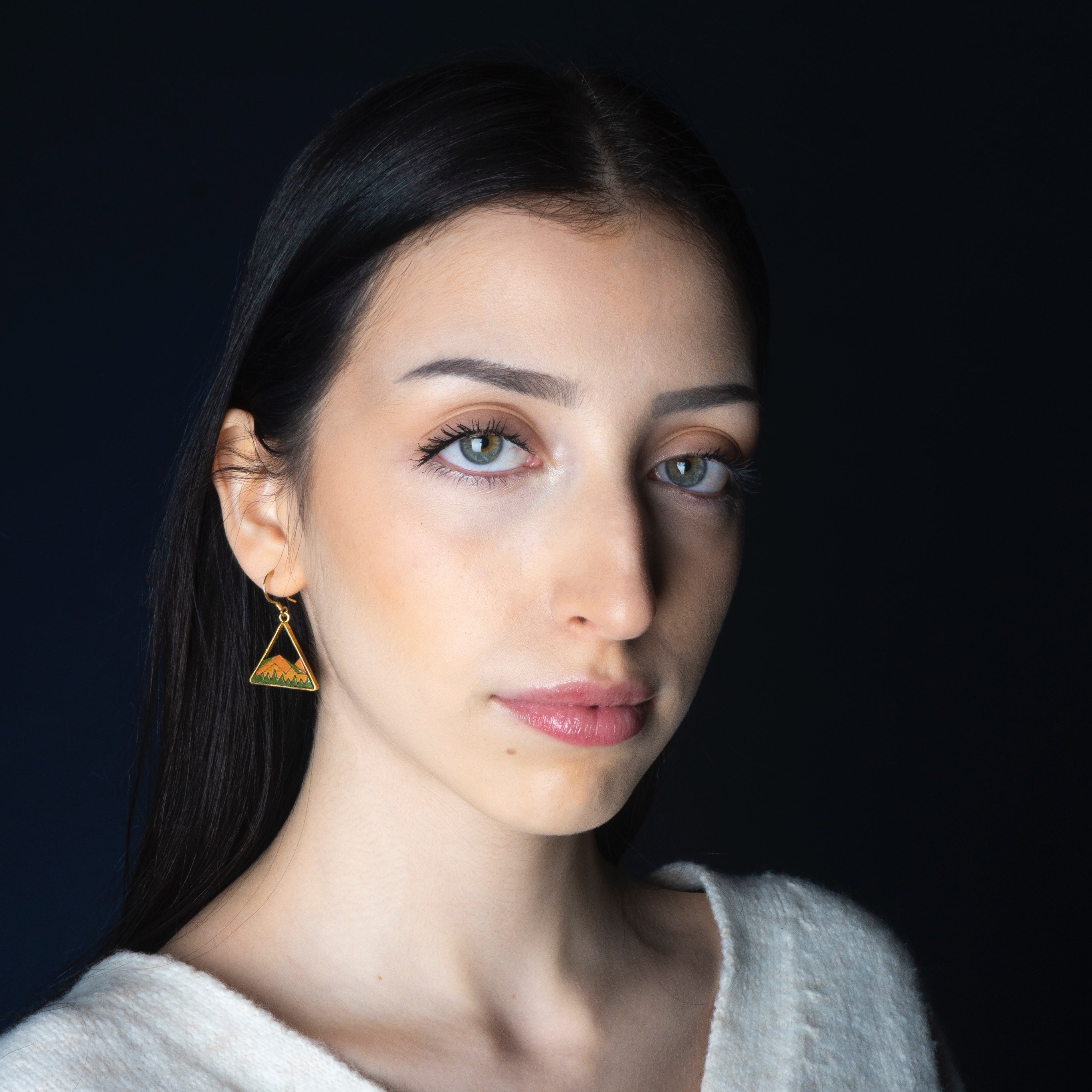 A pair of Hill Eco-friendly Recycled Wood Gold Earrings, showcasing unique wood patterns and 24K gold plating, elegantly displayed in a luxury gift box.