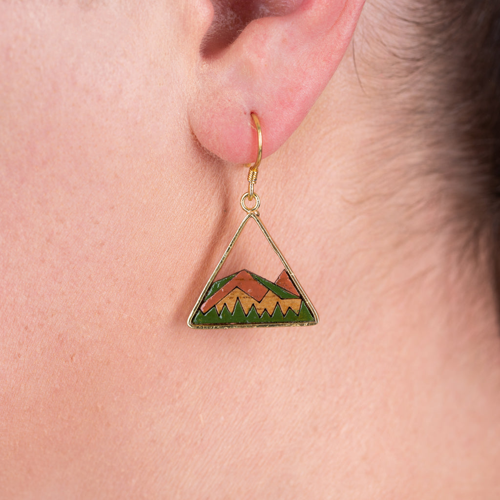 A pair of Hill Eco-friendly Recycled Wood Gold Earrings, showcasing unique wood patterns and 24K gold plating, elegantly displayed in a luxury gift box.