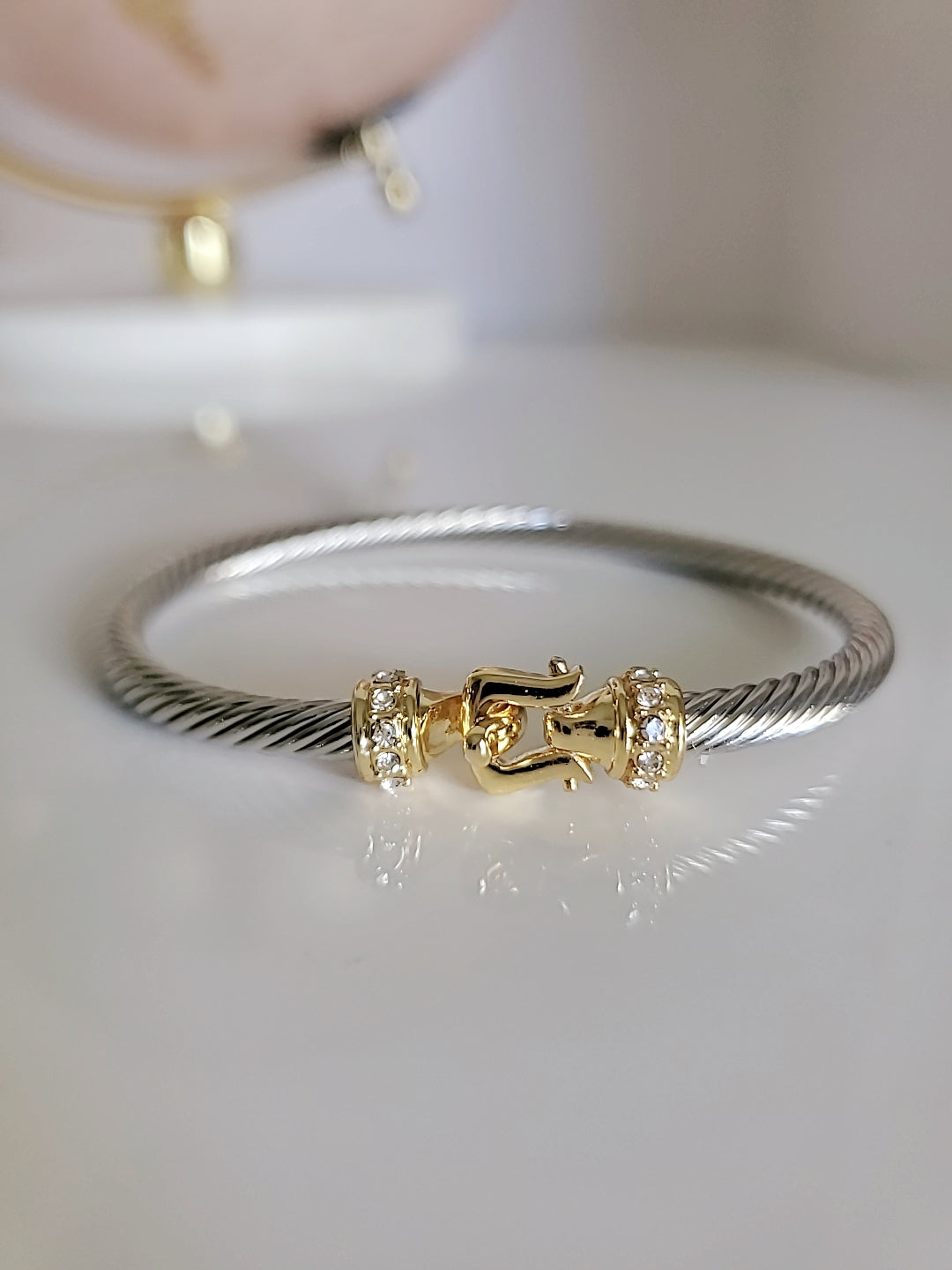 A stunning Hook Bangle Bracelet featuring an 18K Gold Filled design with a unique hook closure, made from durable stainless steel.