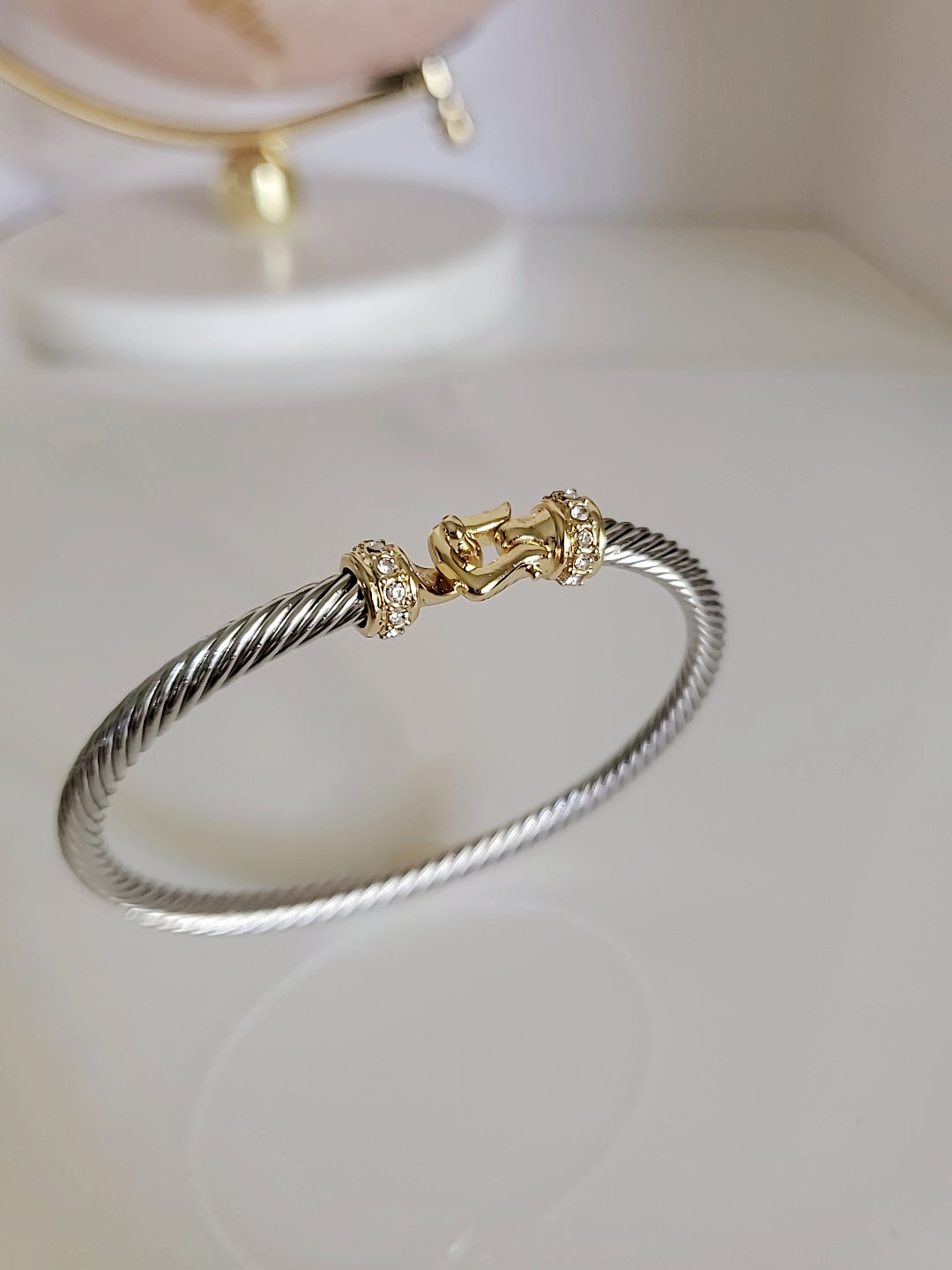 A stunning Hook Bangle Bracelet featuring an 18K Gold Filled design with a unique hook closure, made from durable stainless steel.