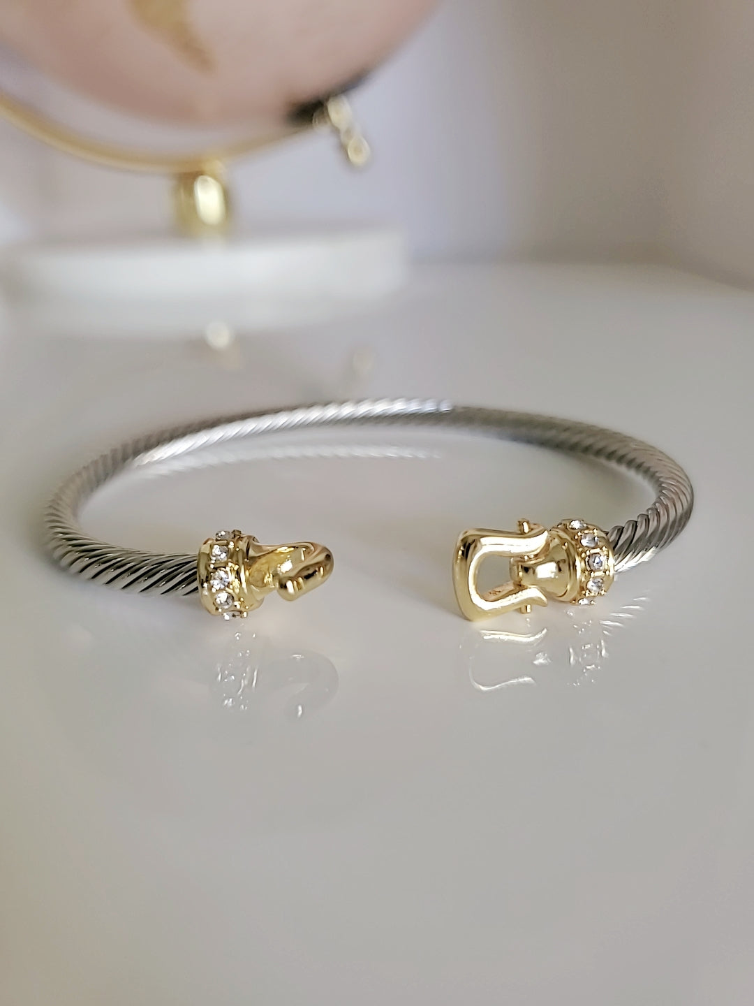 A stunning Hook Bangle Bracelet featuring an 18K Gold Filled design with a unique hook closure, made from durable stainless steel.