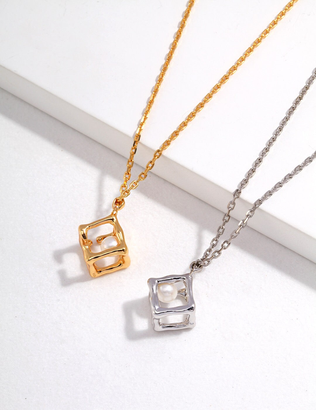 Hollow Geometric Cube Pendant Necklace featuring natural pearls and sterling silver, elegantly designed for a sophisticated look.