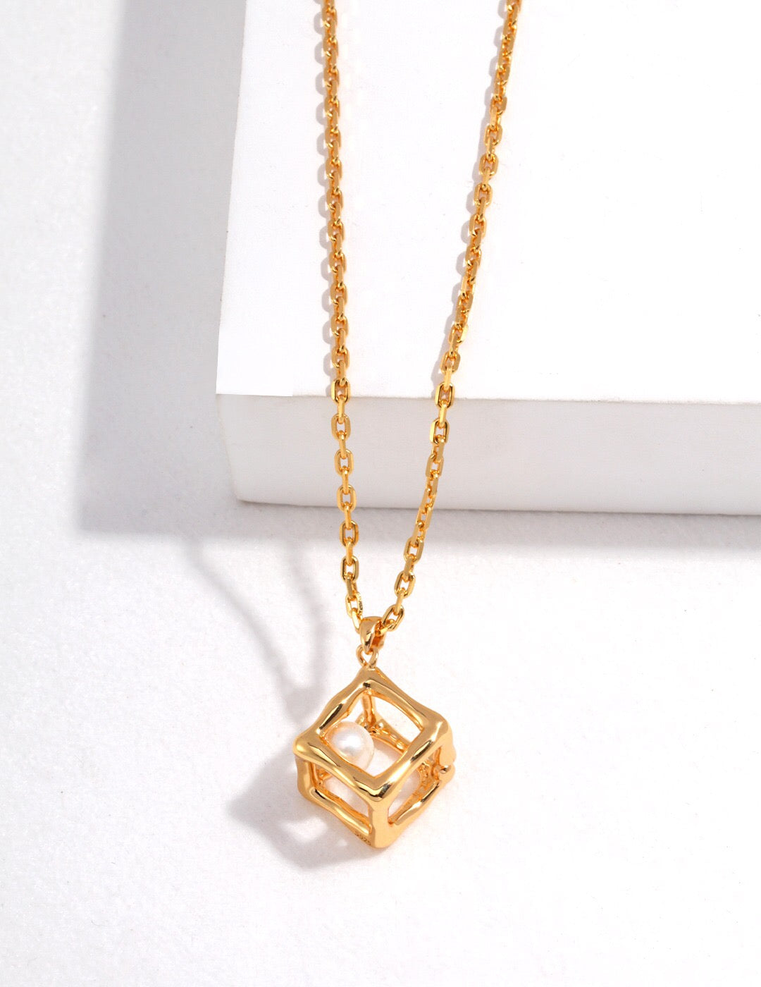 Hollow Geometric Cube Pendant Necklace featuring natural pearls and sterling silver, elegantly designed for a sophisticated look.