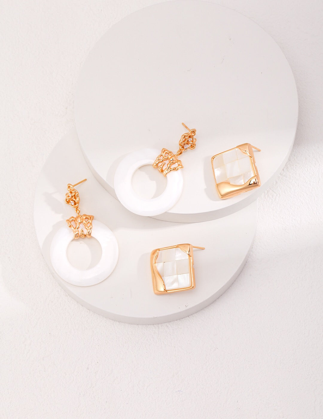 A pair of handmade Hollow Round Shell Drop Earrings featuring natural shell, sterling silver, and gold vermeil, elegantly displayed.