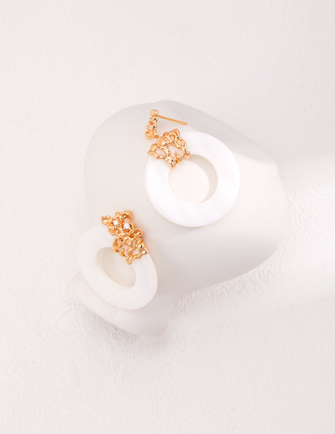 A pair of handmade Hollow Round Shell Drop Earrings featuring natural shell, sterling silver, and gold vermeil, elegantly displayed.