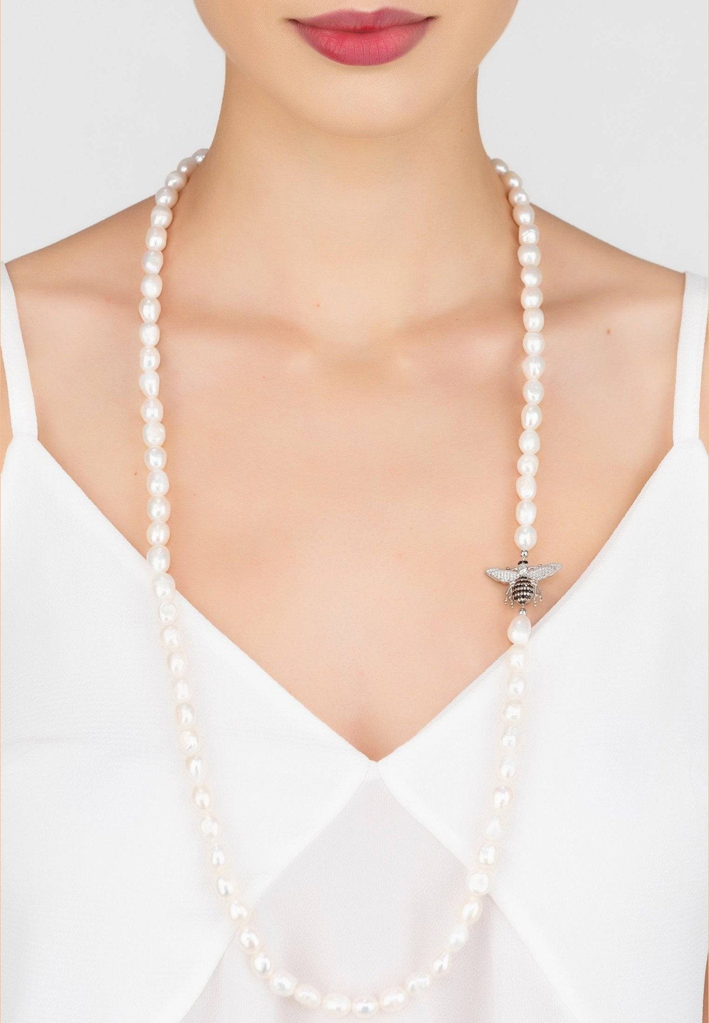 Honey Bee Pearl Gemstone Long Necklace in silver featuring a pearl and zirconia bee motif, elegantly displayed in a jewelry box.