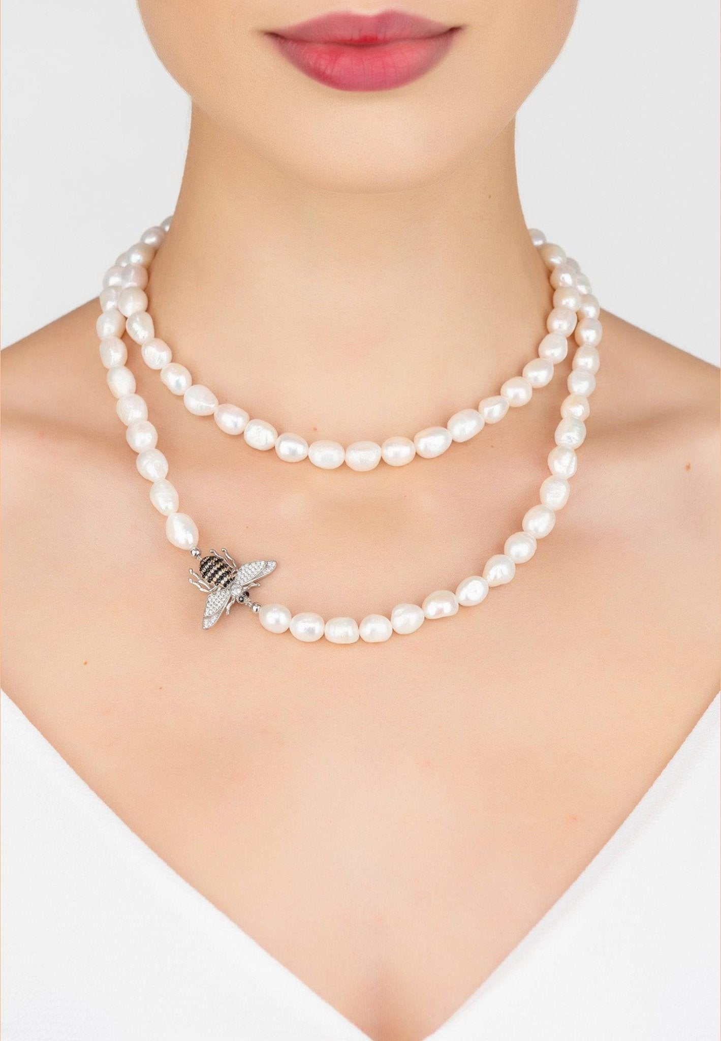 Honey Bee Pearl Gemstone Long Necklace in silver featuring a pearl and zirconia bee motif, elegantly displayed in a jewelry box.