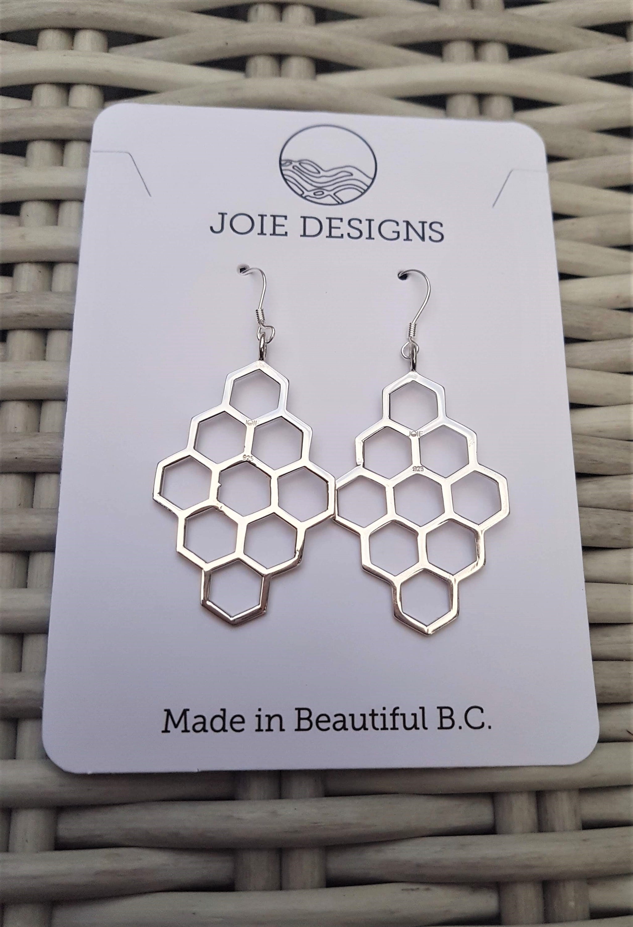 A pair of elegant sterling silver honeycomb earrings, showcasing a unique design with a polished finish.