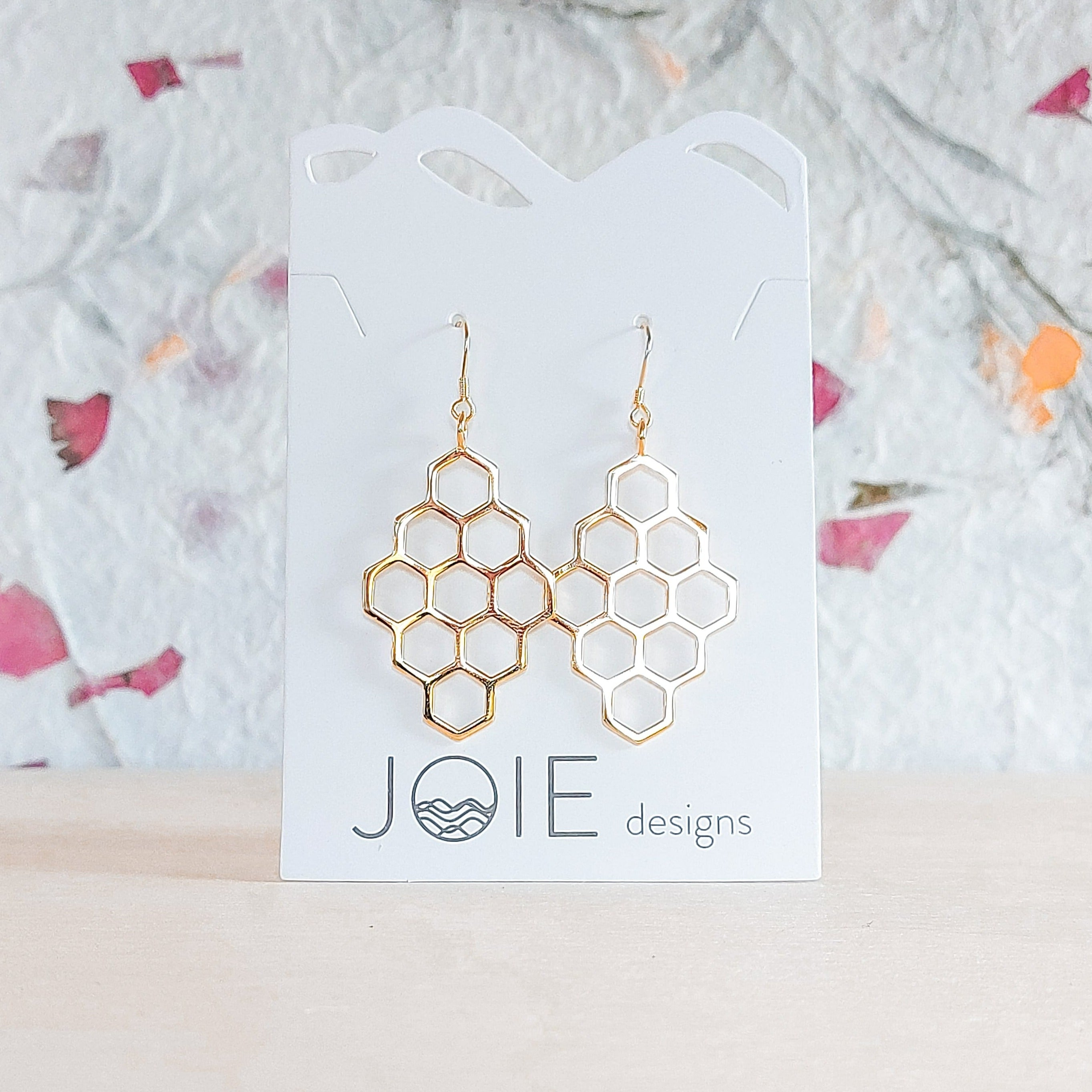 A pair of elegant sterling silver honeycomb earrings, showcasing a unique design with a polished finish.