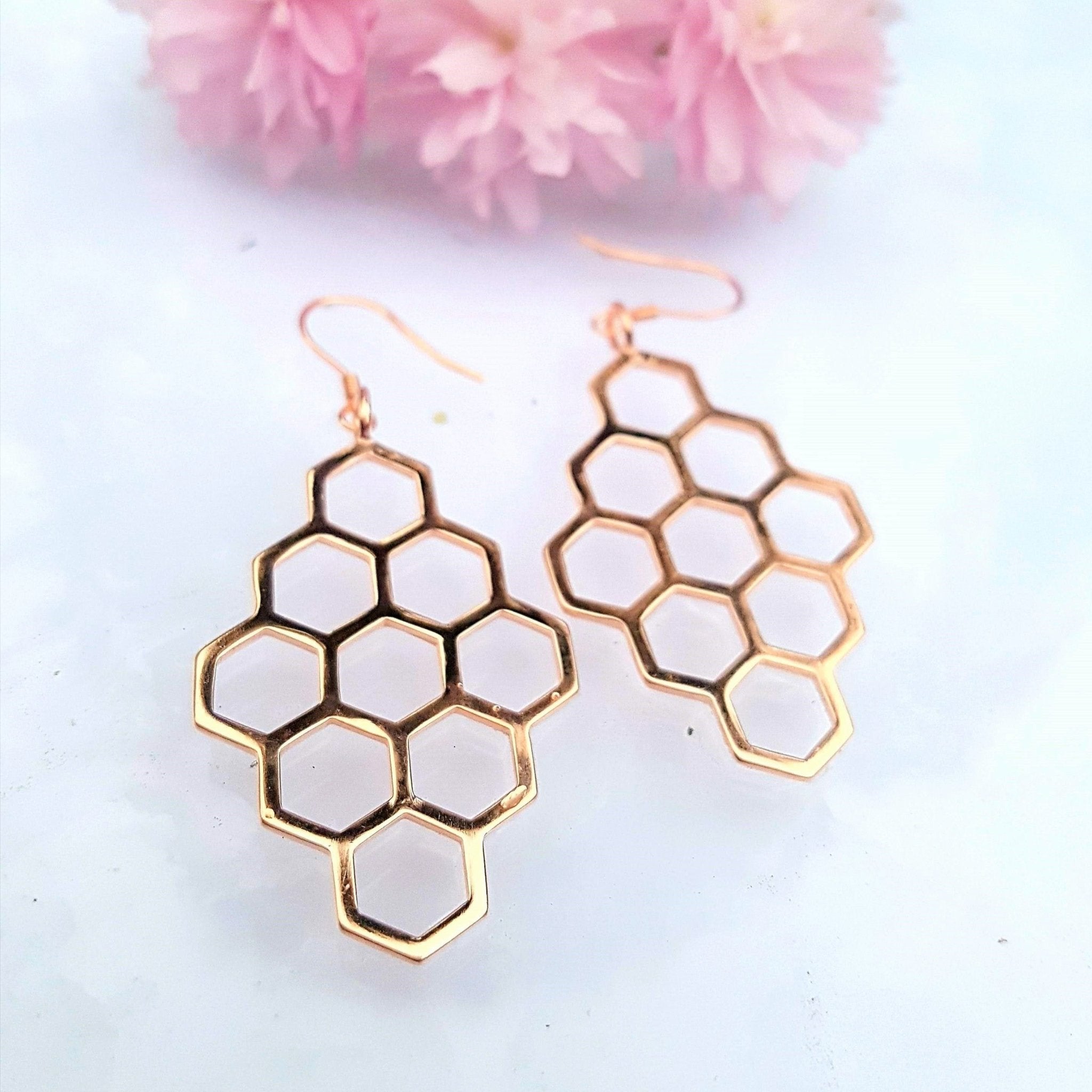 A pair of elegant sterling silver honeycomb earrings, showcasing a unique design with a polished finish.