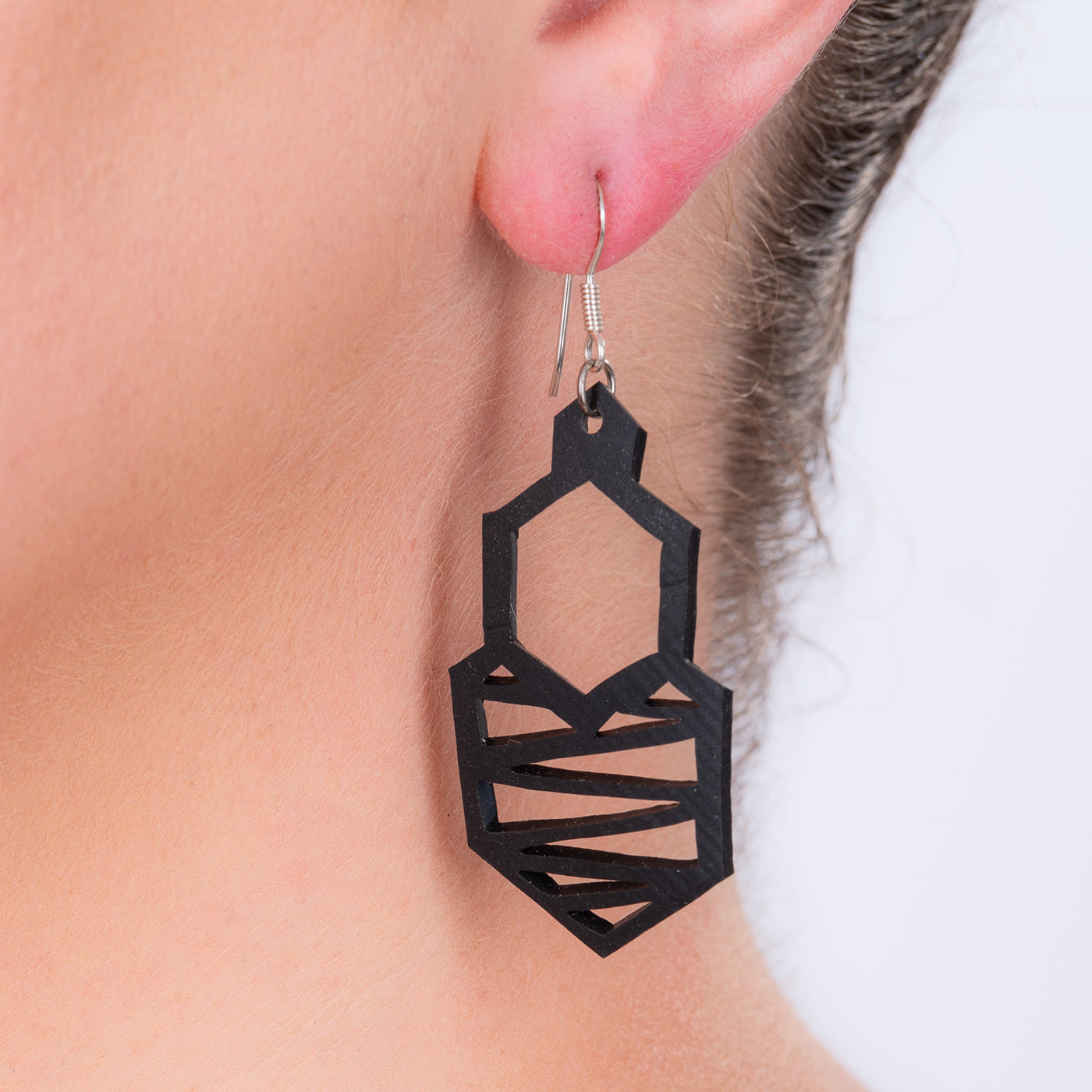 A pair of Honeycomb Handmade Rubber Earrings showcasing a unique lattice design, crafted from reclaimed tyre inner tubes with sterling silver hooks.