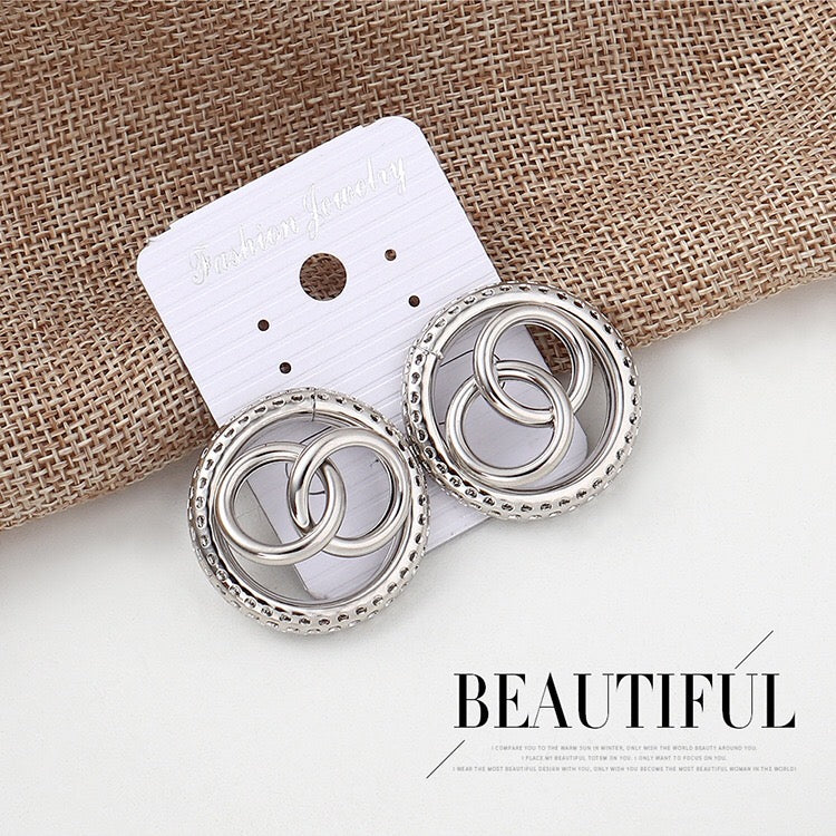 A pair of stylish honeycomb hoop earrings made from alloy and steel, showcasing an intricate design.