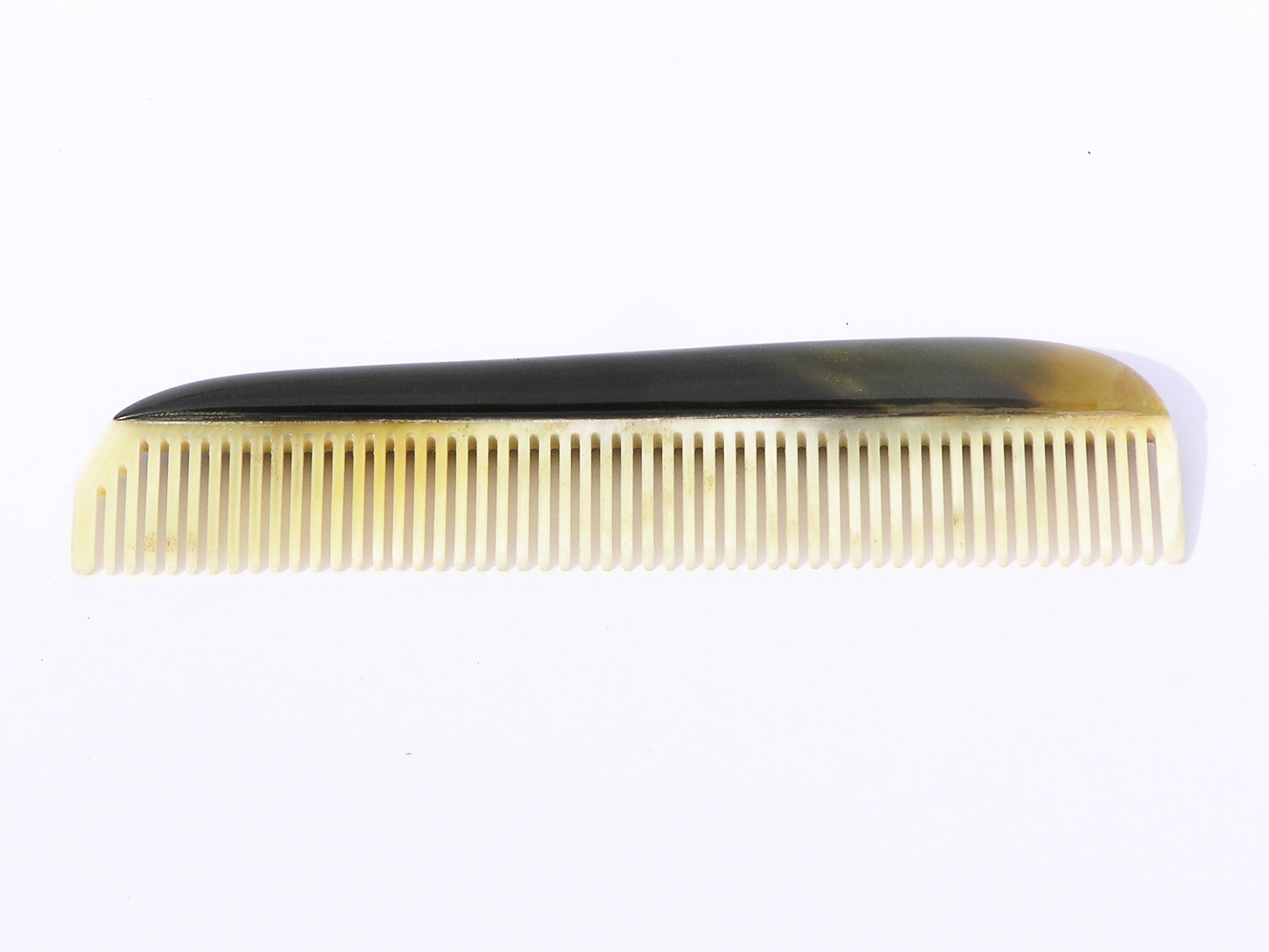 Elegant horn comb with unique patterns and smooth finish, perfect for men's grooming.