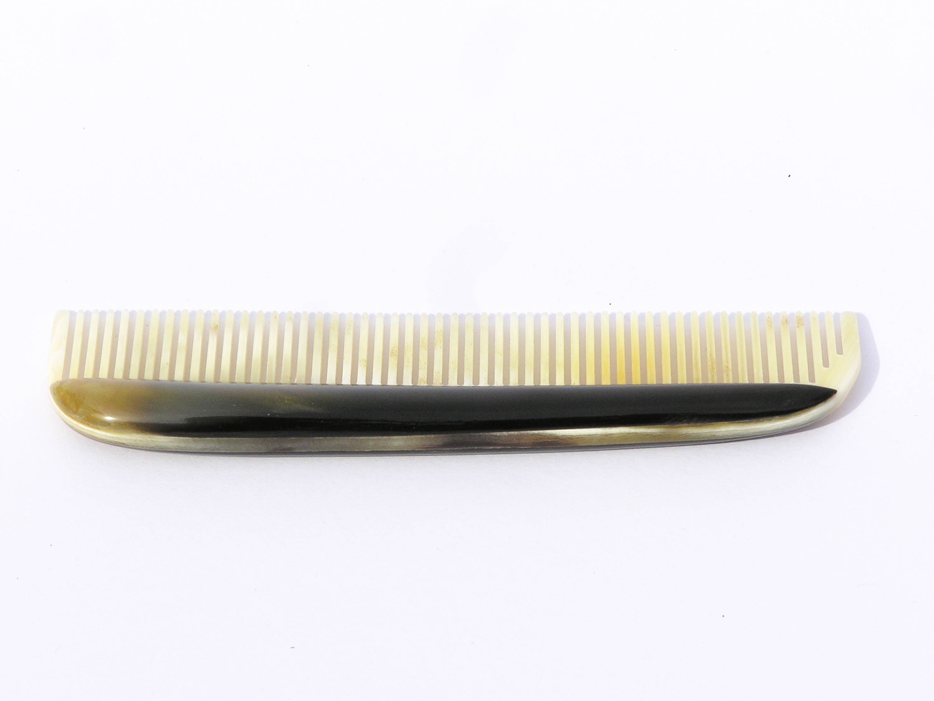 Elegant horn comb with unique patterns and smooth finish, perfect for men's grooming.