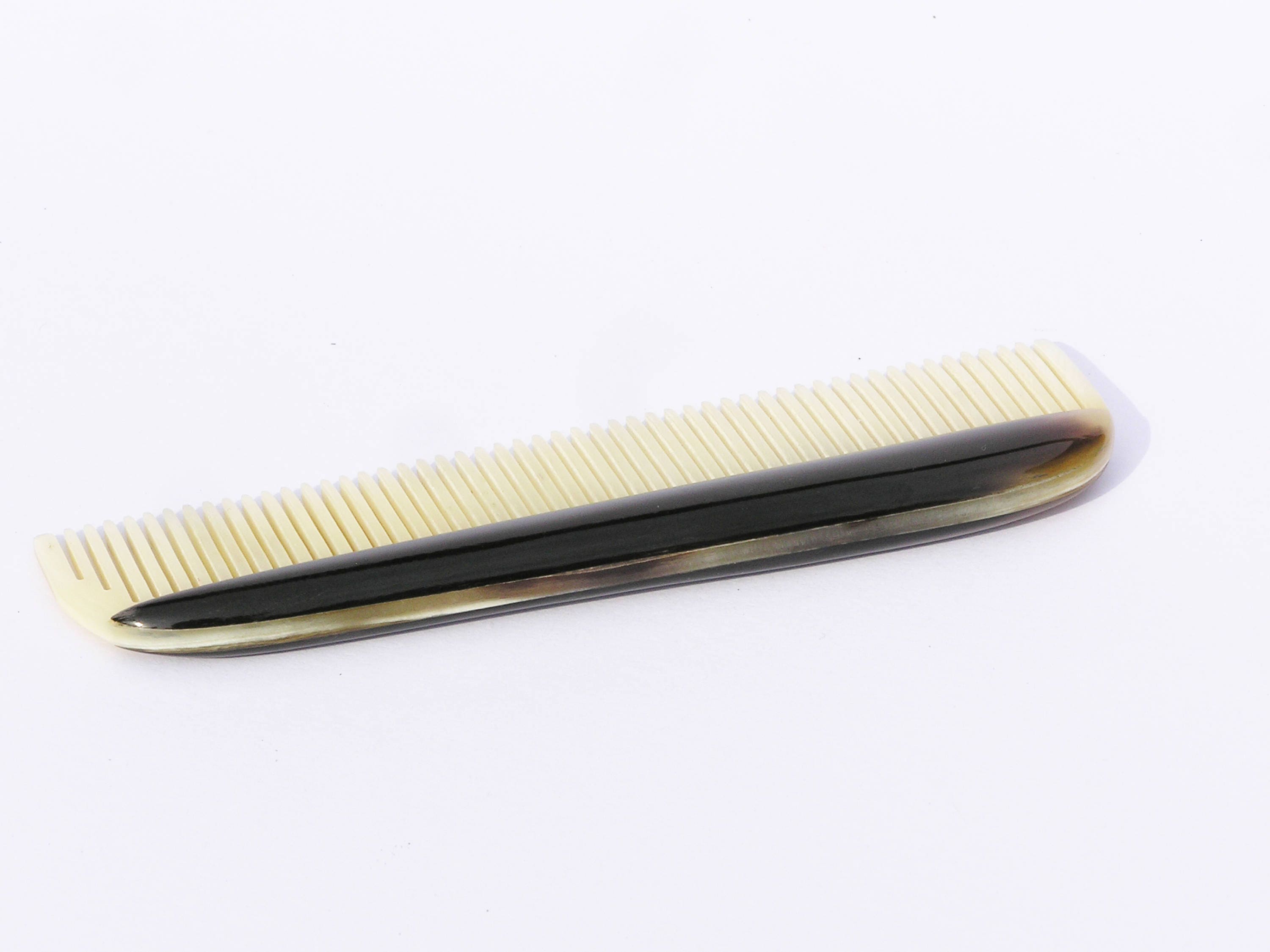 Elegant horn comb with unique patterns and smooth finish, perfect for men's grooming.