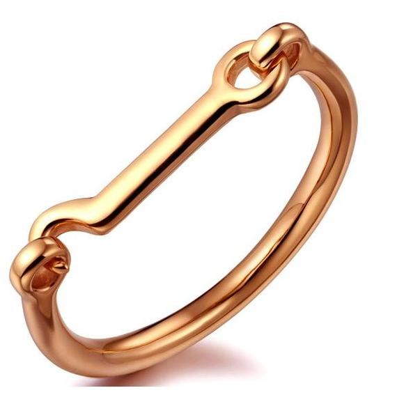 A stylish 14k gold plated horsebit bangle, showcasing its elegant design and shiny finish.