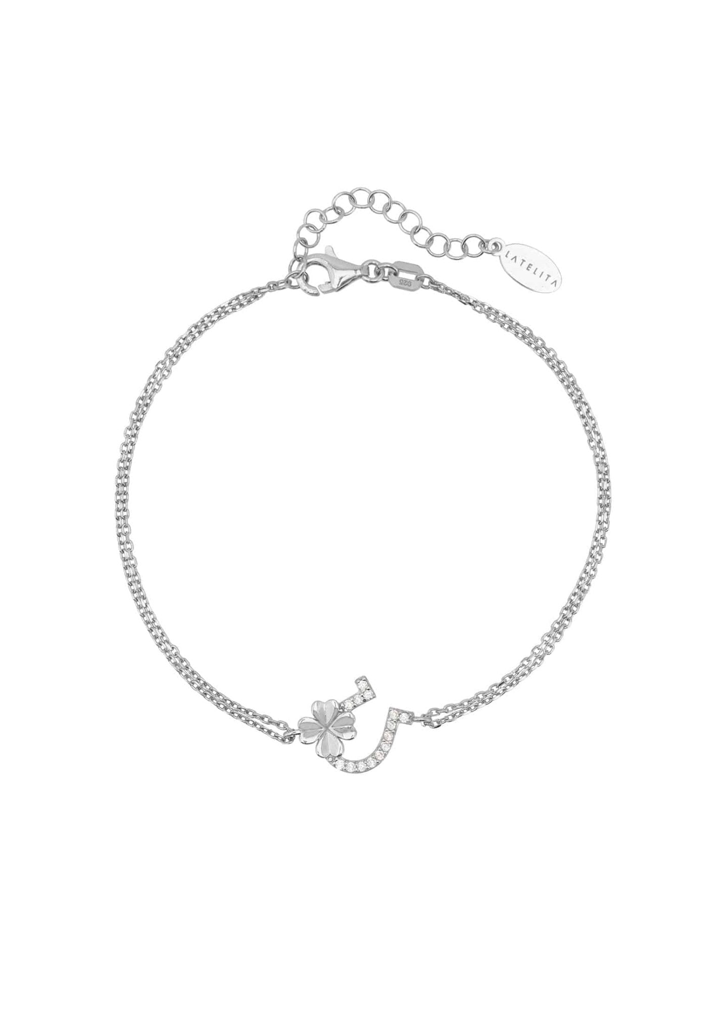 Elegant silver bracelet featuring horseshoe and shamrock motifs, adorned with white zirconia.