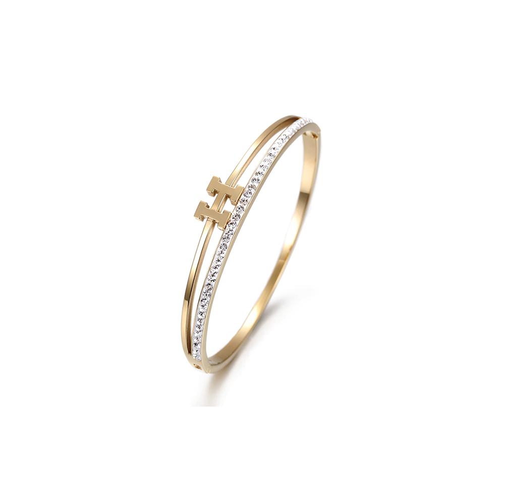 Elegant H-shaped CZ Bangle made of surgical stainless steel with gold plating and sparkling cubic zirconia stones.