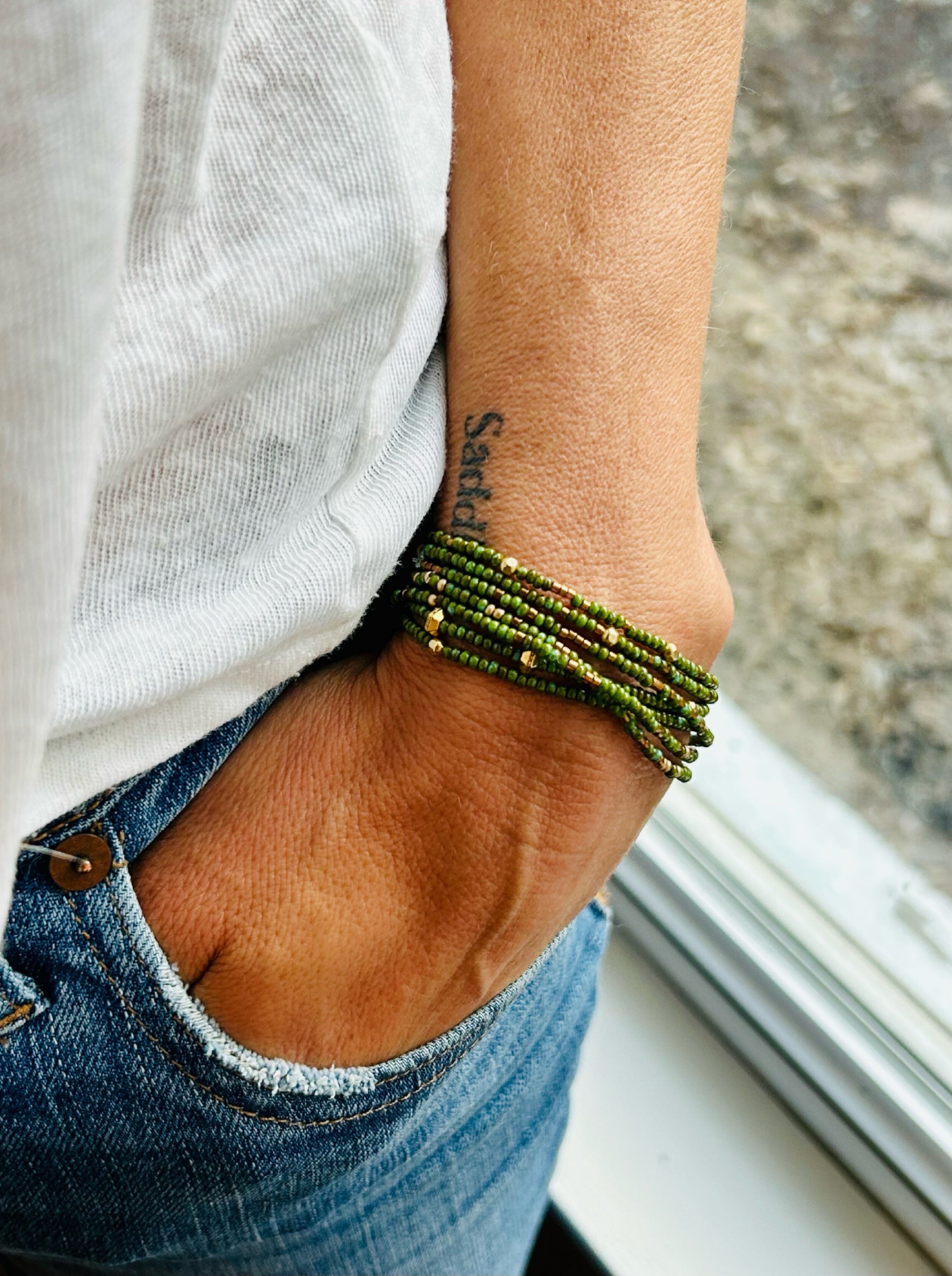 Hunter Green & Gold-Sprinkle Beaded Boho Wrap Bracelet featuring dark green Czech glass beads and metallic gold accents, elegantly wrapped around a wrist.