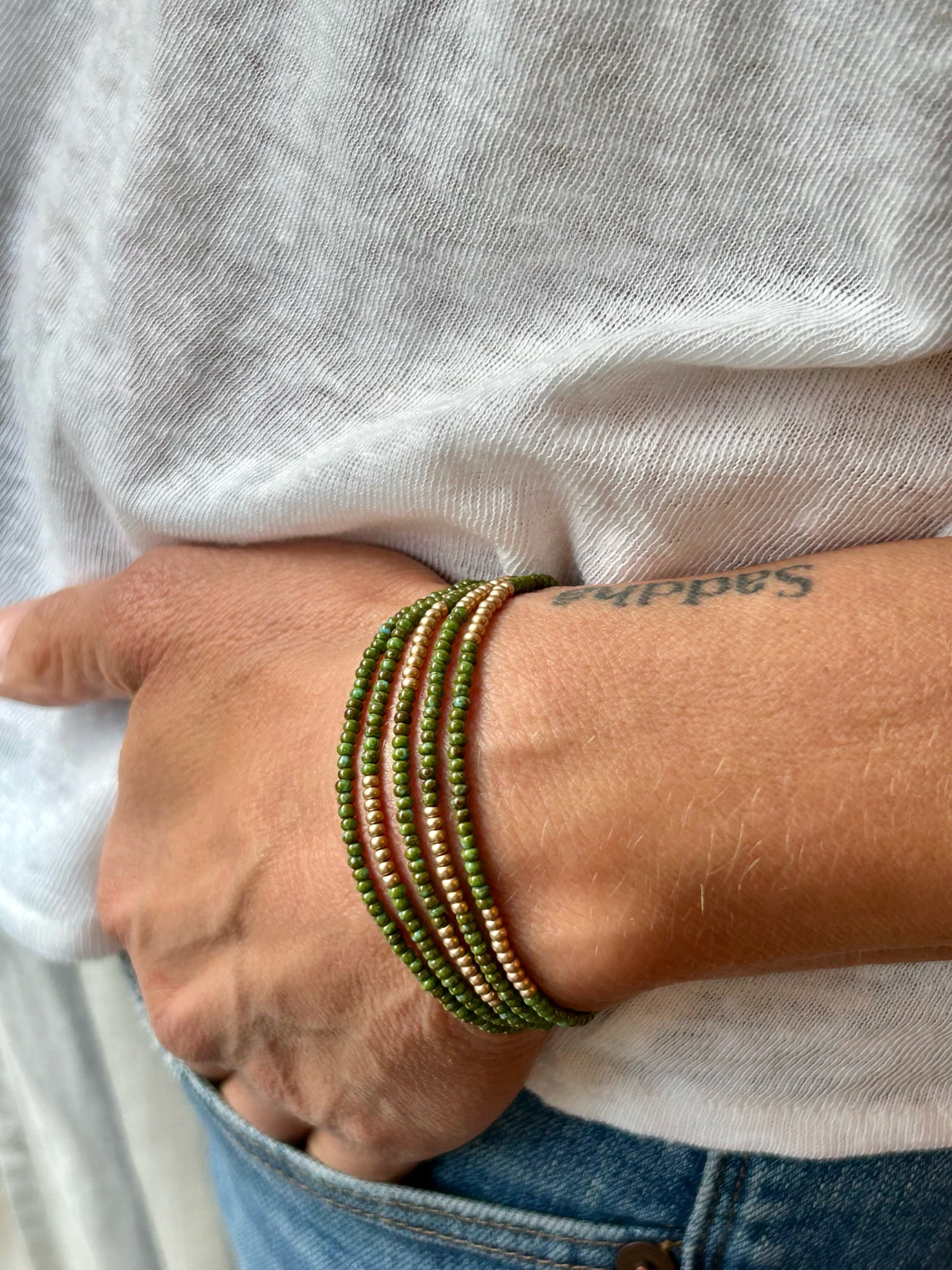 Hunter Green Gold-Striped Beaded 5-Wrap Bracelet featuring Czech glass seed beads and metallic gold accents, elegantly wrapped around a wrist.