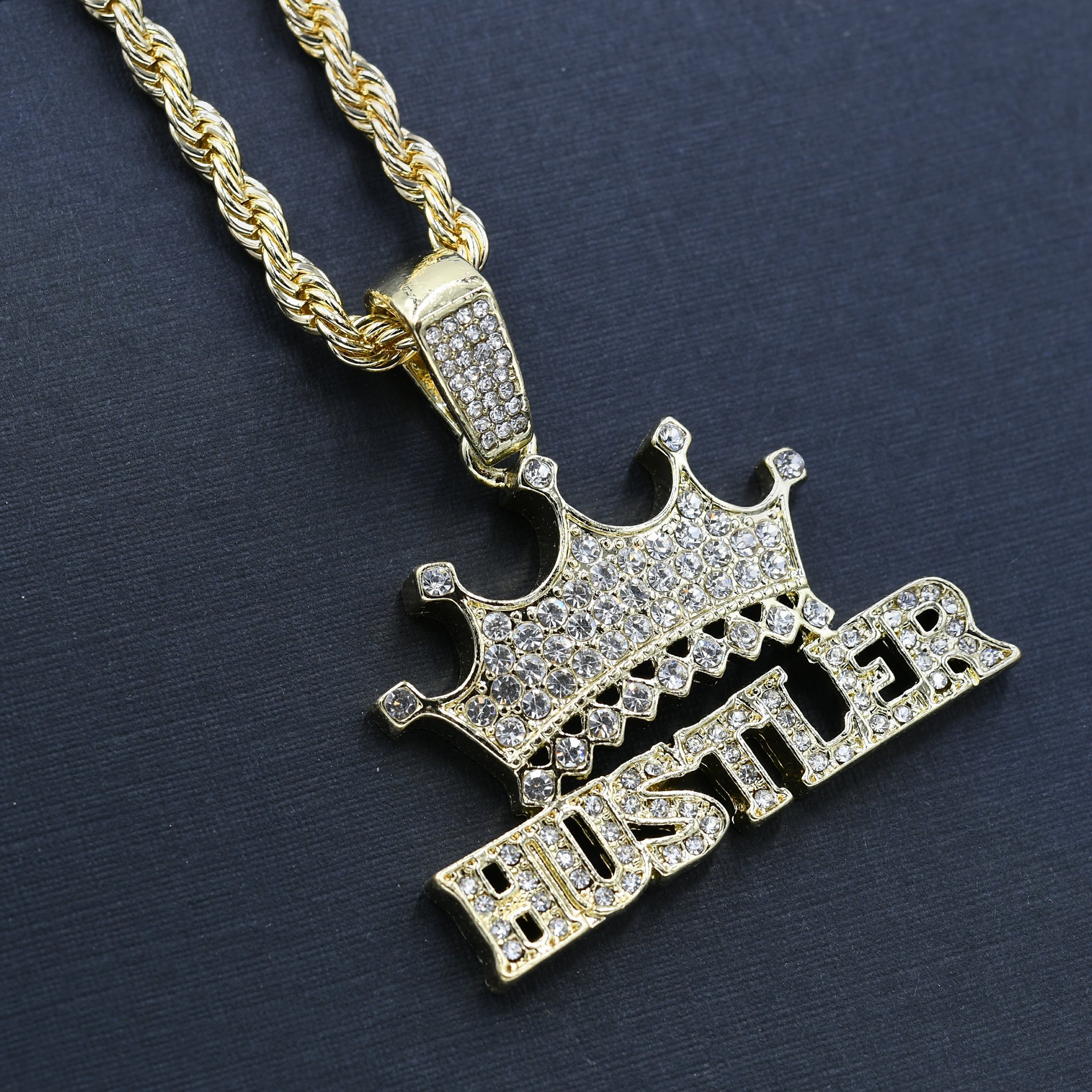 HUSTLER HAND CHAIN AND CHARM featuring a crystal-studded pendant on a 24'' rope chain, showcasing intricate design and bold style.