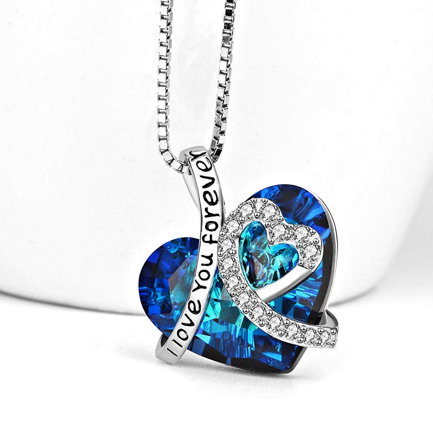 I LOVE YOU FOREVER Blue Crystal Heart Necklace in 18K White Gold, featuring a heart-shaped Bermuda Blue crystal and elegant gift box.