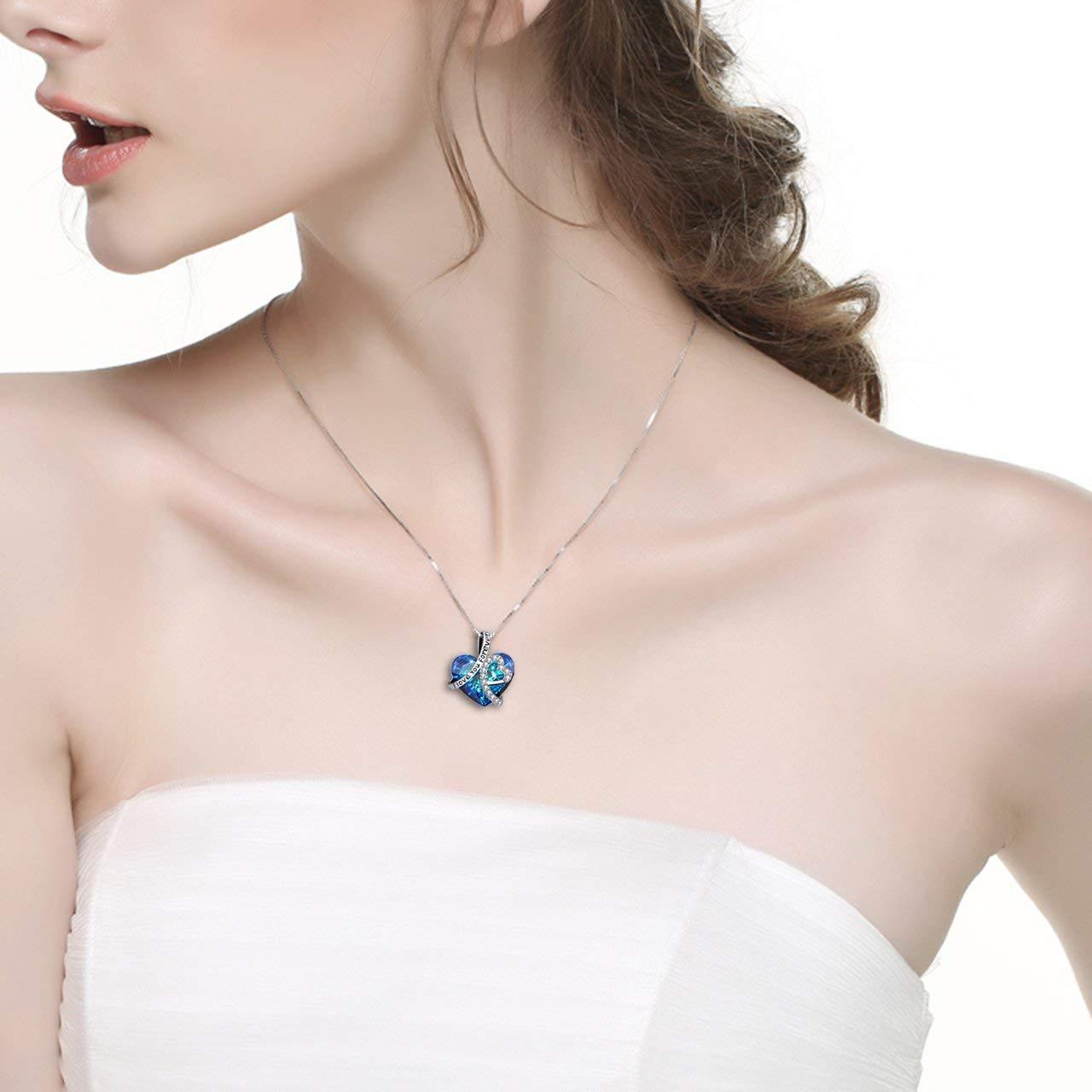 I LOVE YOU FOREVER Blue Crystal Heart Necklace in 18K White Gold, featuring a heart-shaped Bermuda Blue crystal and elegant gift box.