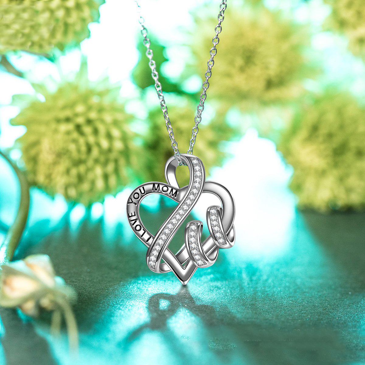 I Love You Mom Heart Necklace featuring a rhodium plated heart pendant with cubic zirconia stones on a link chain.