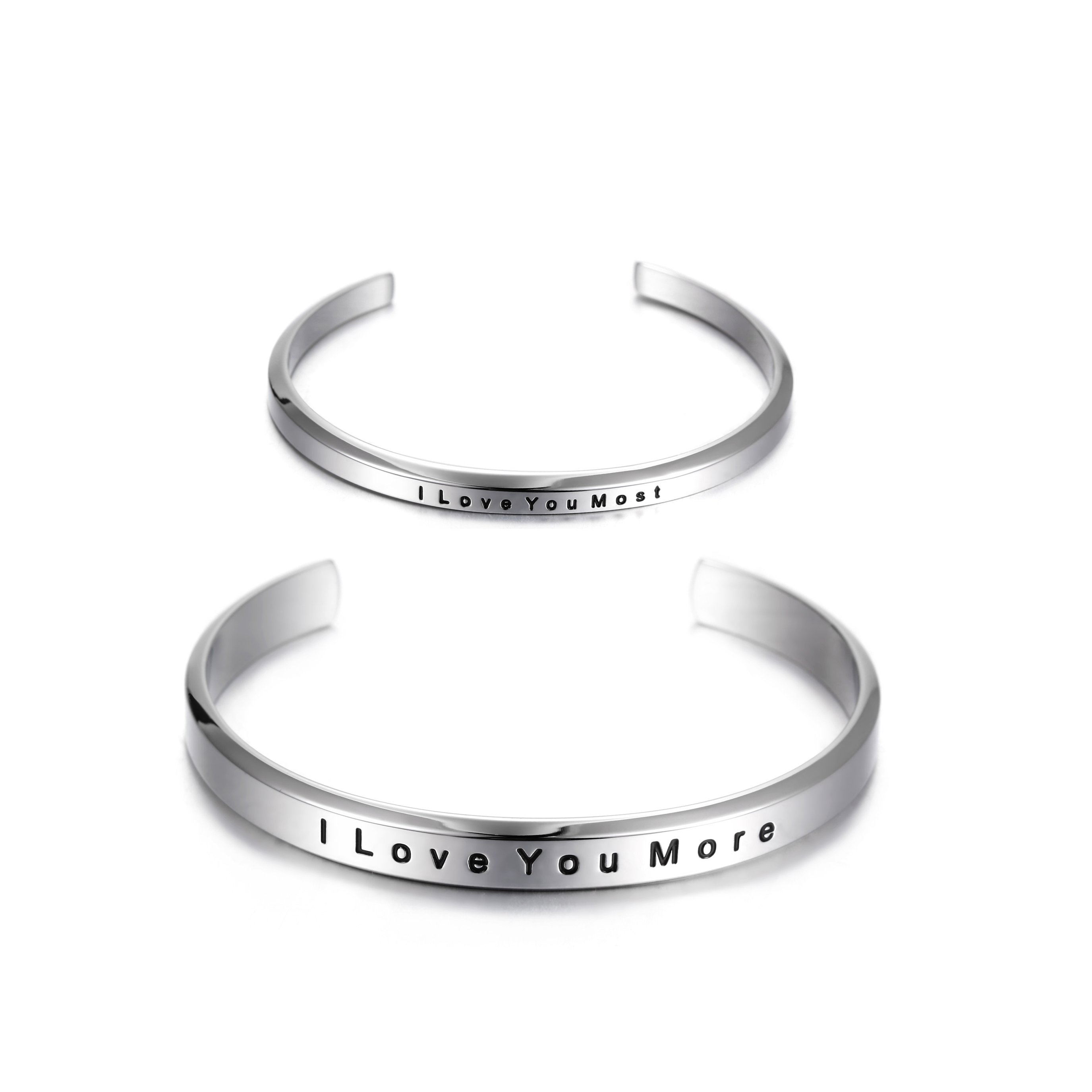 A pair of elegant couple cuffs inscribed with 'I Love You More' and 'I Love You Most', made from stainless steel with gold plating.