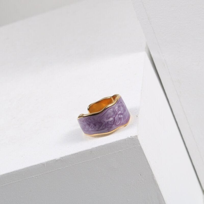 A collection of colorful Ice Cream Enamel Glaze Rings featuring vibrant colors and a shiny gold finish, displayed elegantly.