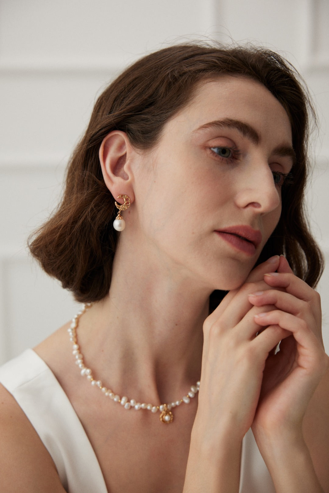 Ideal Love Pearl Necklace featuring a camellia pendant in antique gold, adorned with natural seawater pearls, showcasing elegance and romance.