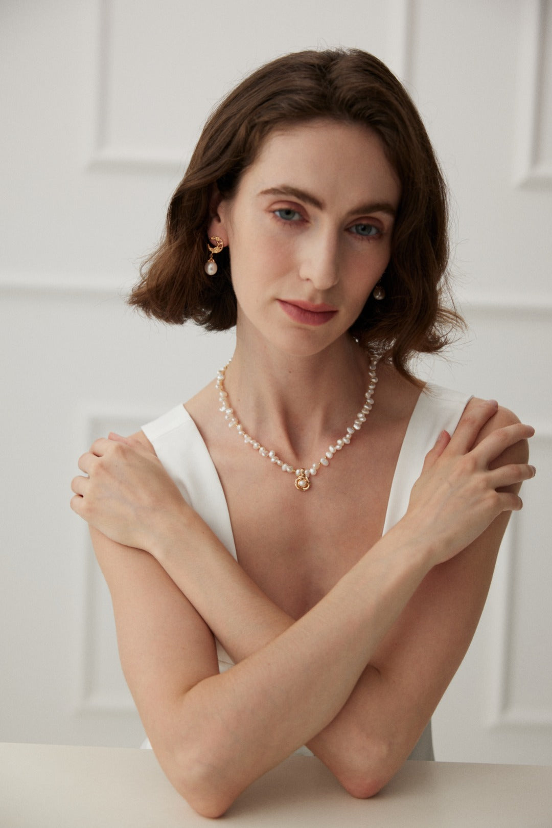 Ideal Love Pearl Necklace featuring a camellia pendant in antique gold, adorned with natural seawater pearls, showcasing elegance and romance.