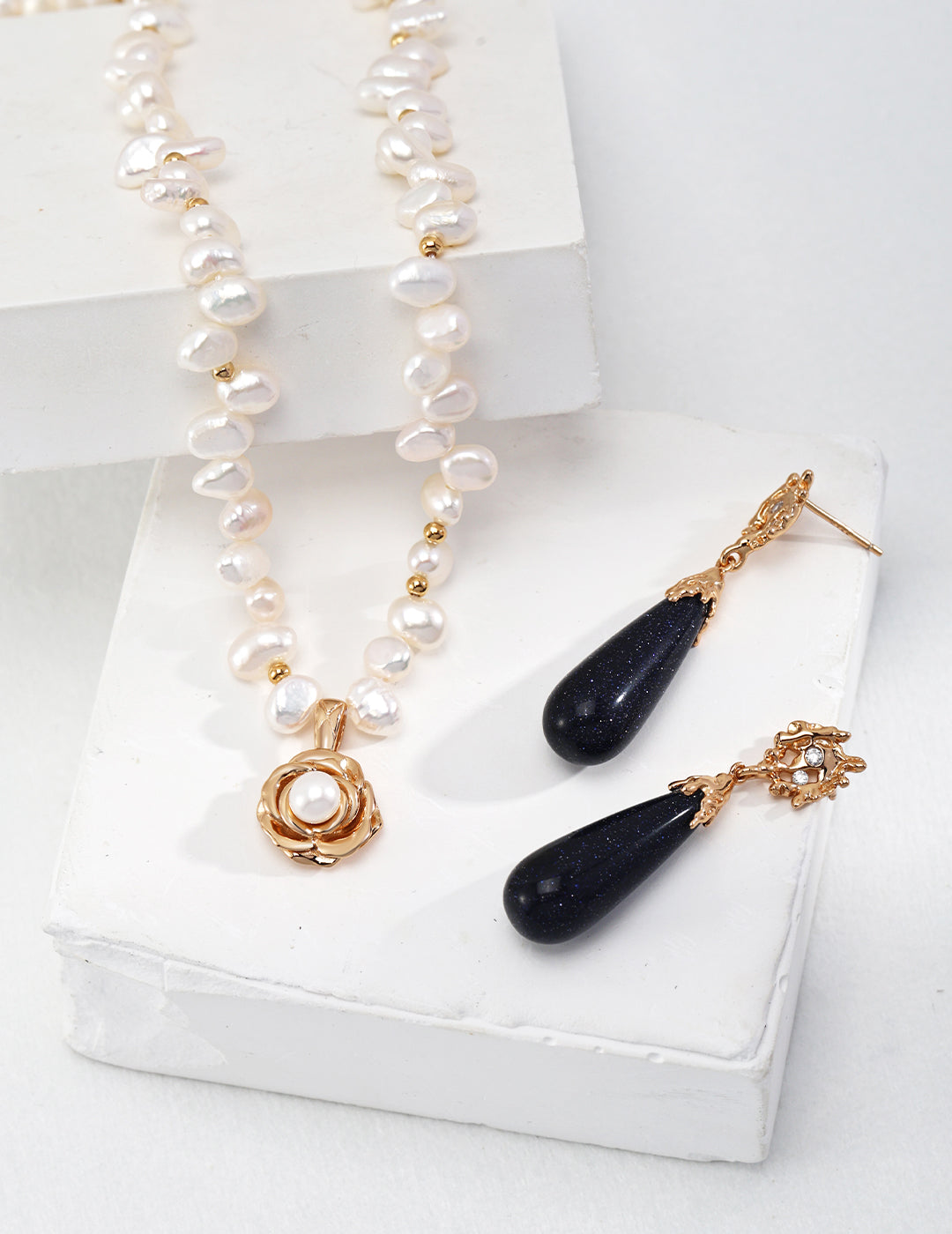 Ideal Love Pearl Necklace featuring a camellia pendant in antique gold, adorned with natural seawater pearls, showcasing elegance and romance.