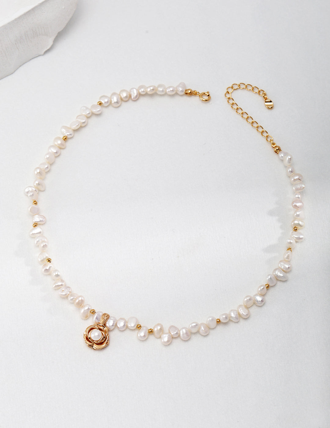 Ideal Love Pearl Necklace featuring a camellia pendant in antique gold, adorned with natural seawater pearls, showcasing elegance and romance.