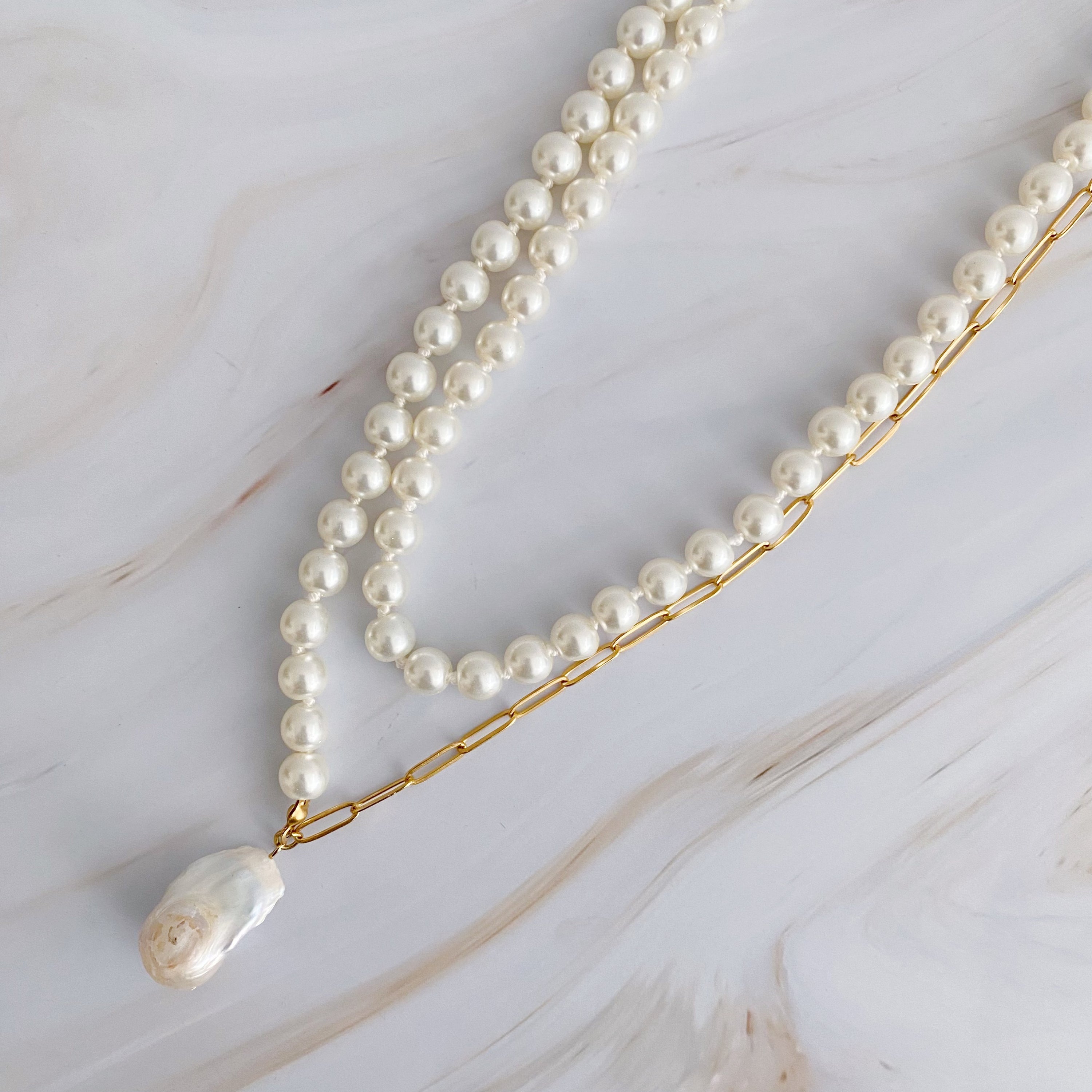 In Your Way Pearl And Chain Long Necklace featuring a baroque pearl pendant and gold plated chain, elegantly displayed.