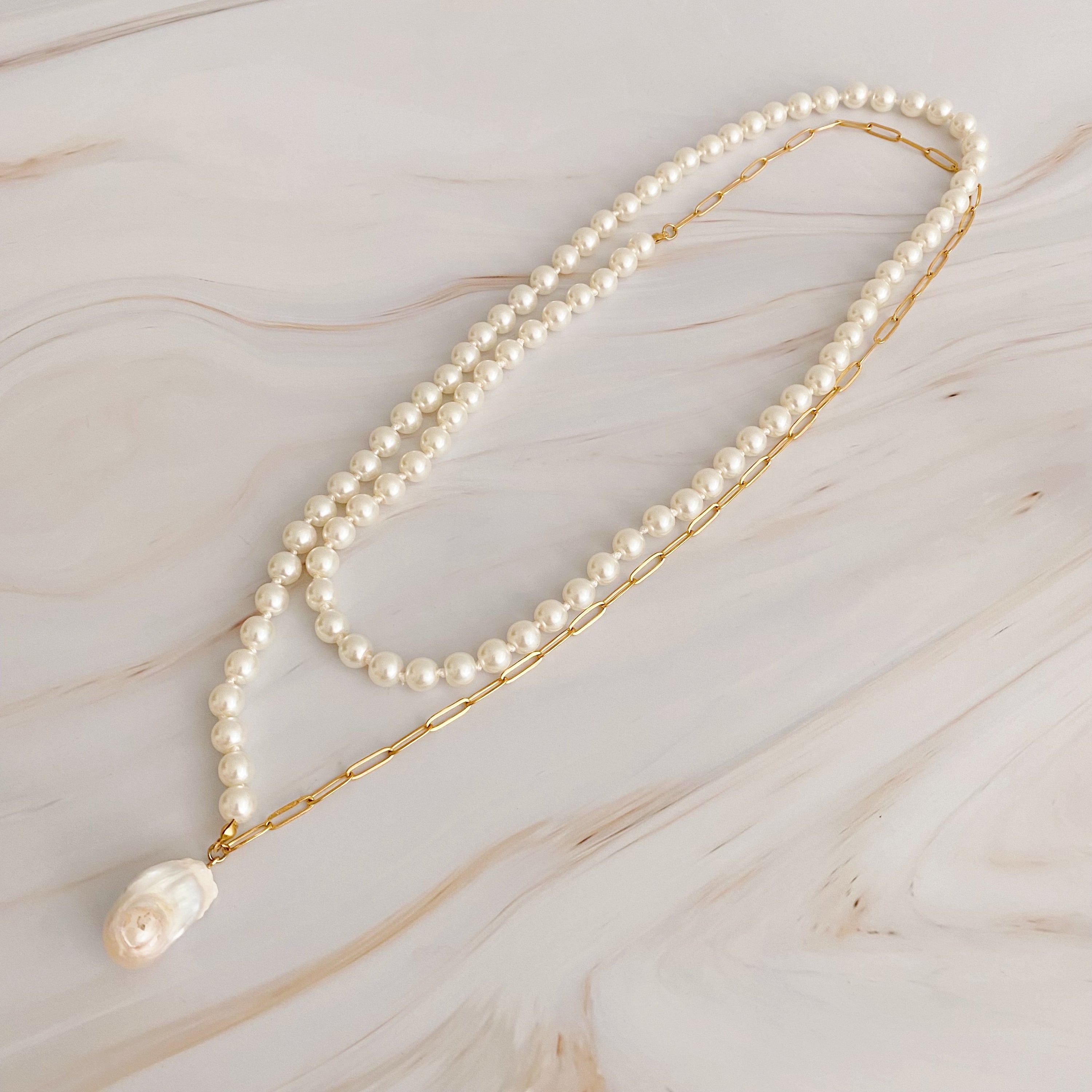 In Your Way Pearl And Chain Long Necklace featuring a baroque pearl pendant and gold plated chain, elegantly displayed.