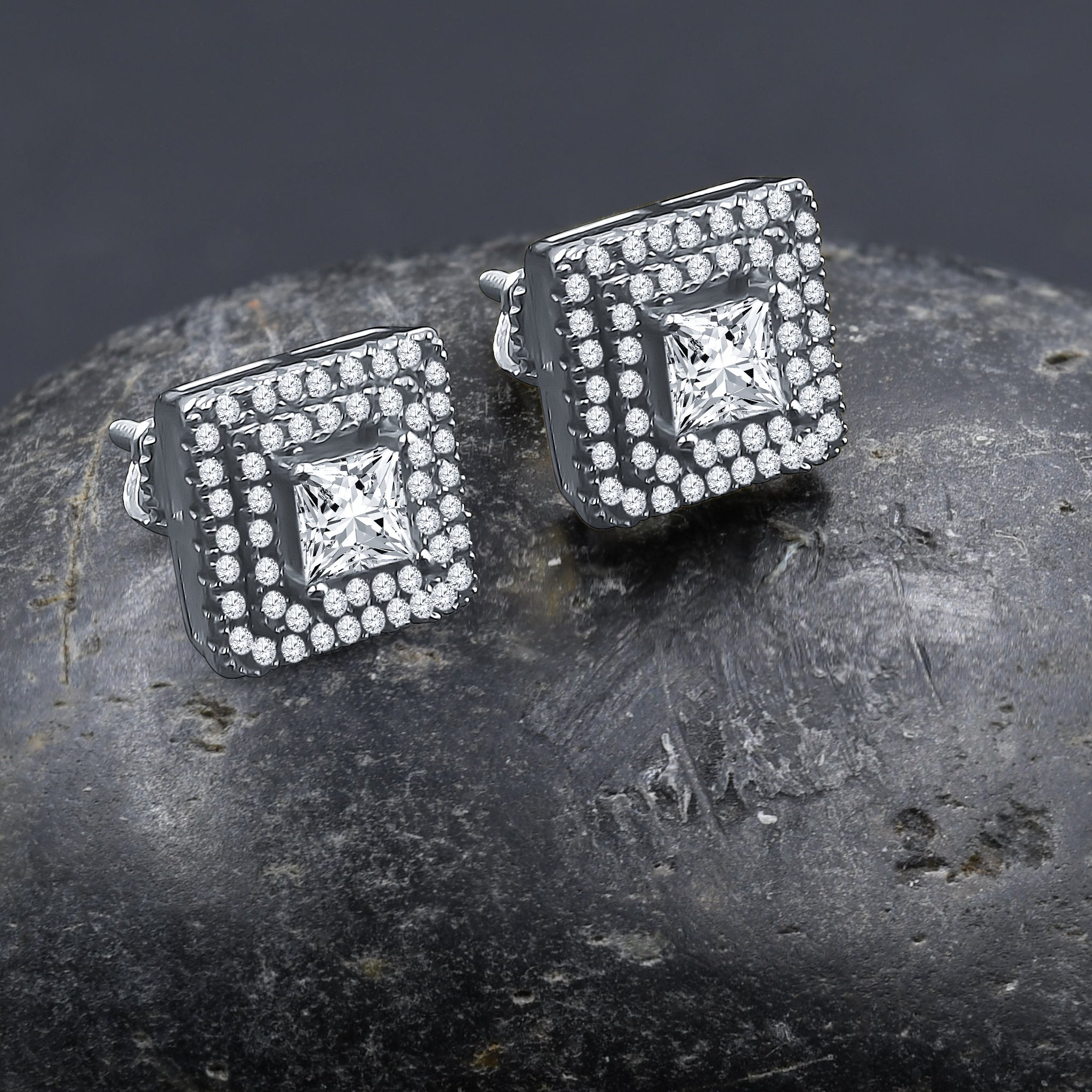 A pair of INCANDESCENT screw back earrings featuring a central cubic zirconia stone and a square motif design, elegantly crafted from brass copper metal.