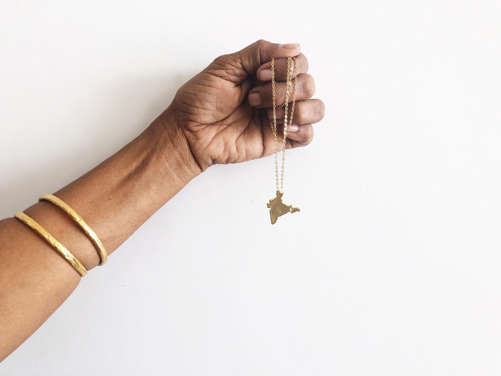 India Unity Pendant featuring 18K gold plating on a brass base, with a 17-inch chain and 2-inch extender.