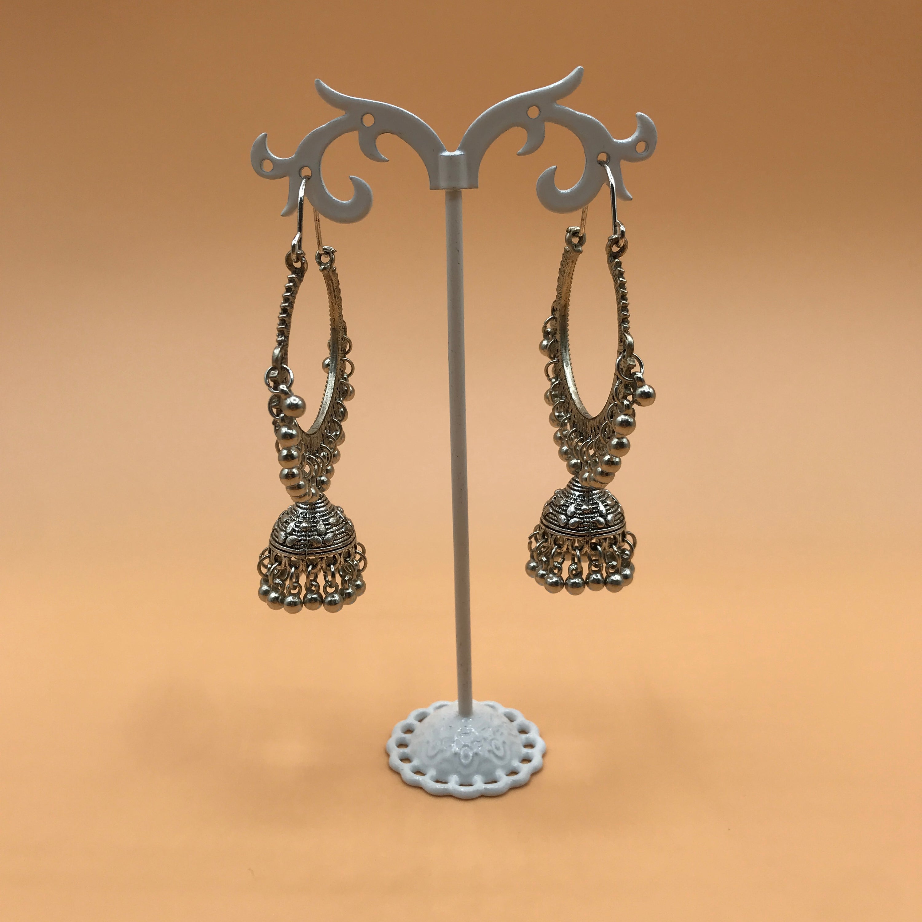 Indian Hollow Circle with Bell Tassel, featuring an elegant hollow design and a charming bell, made from durable alloy.