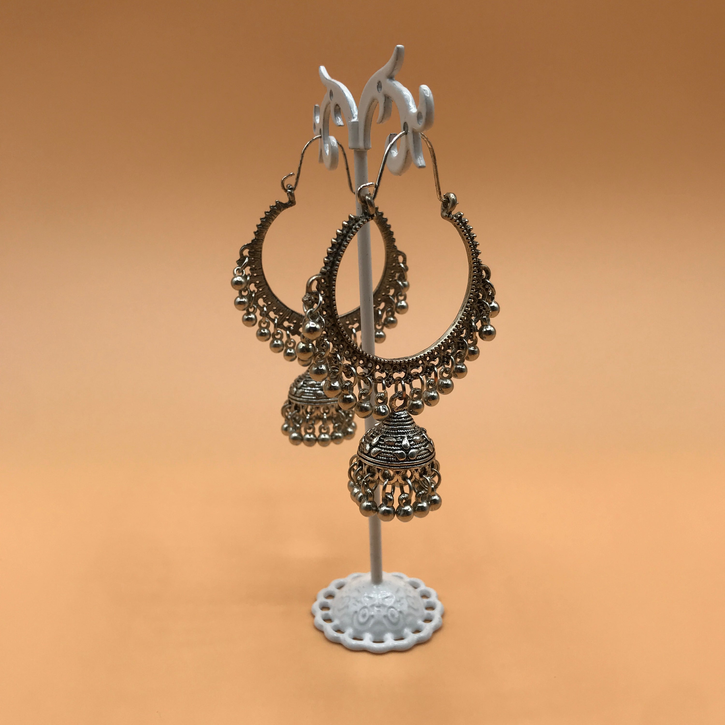 Indian Hollow Circle with Bell Tassel, featuring an elegant hollow design and a charming bell, made from durable alloy.