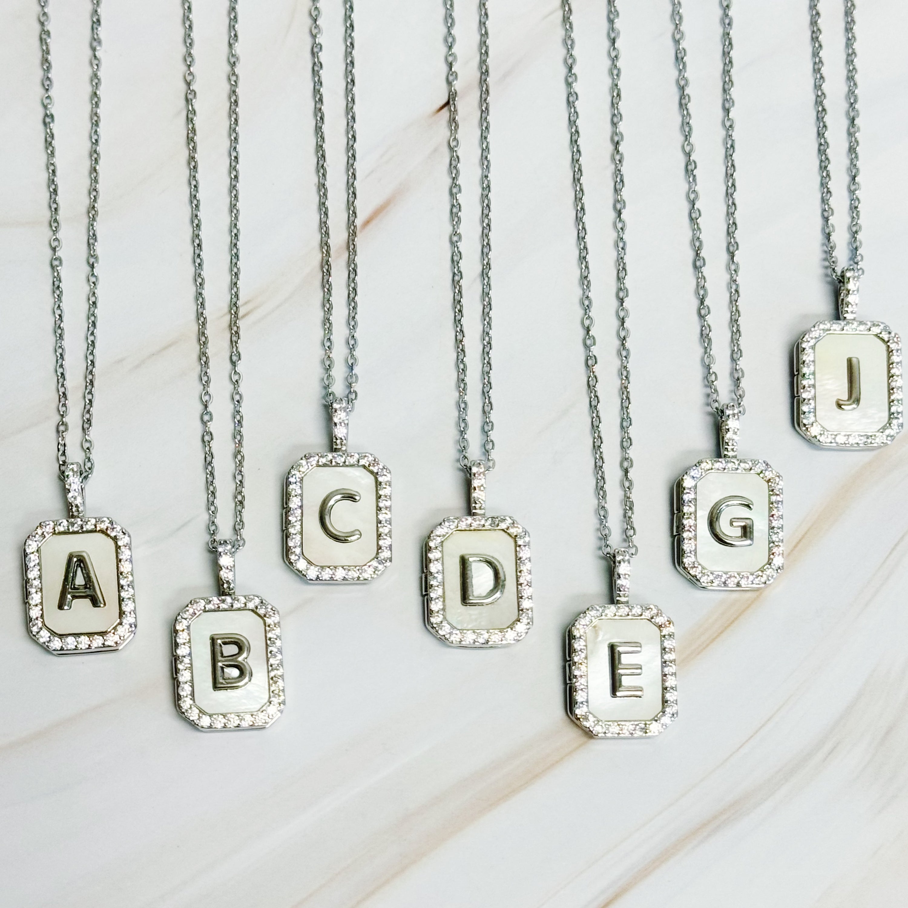 Initial Deco Open Locket Pendant Necklace featuring mother of pearl and cubic zirconia, octagon shape with customizable initial.