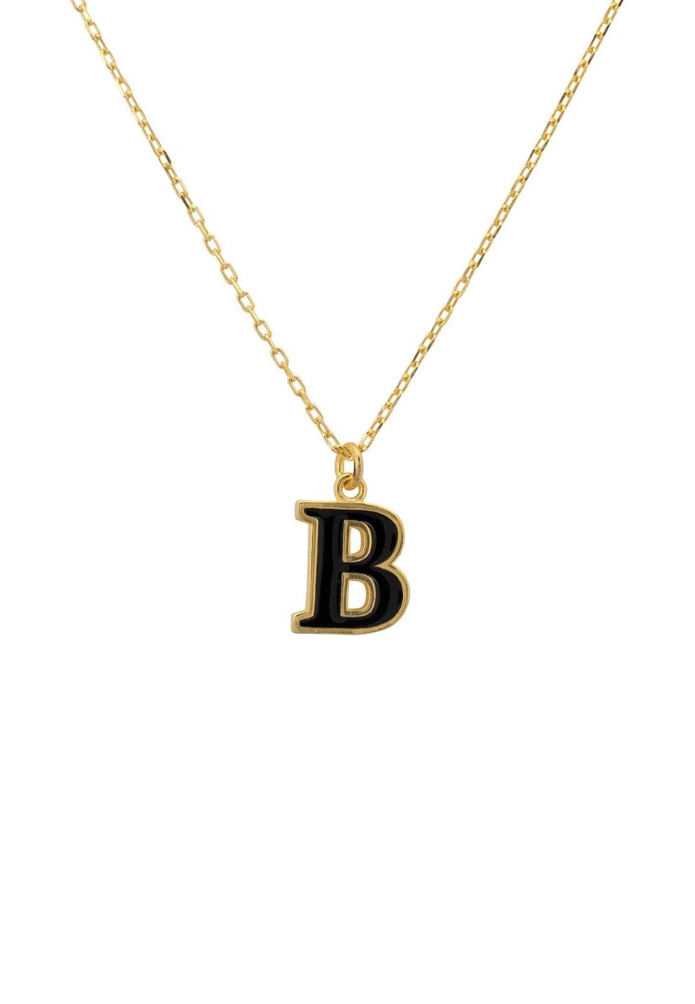 A delicate gold necklace featuring an initial pendant with black enamel inlay, elegantly displayed in a jewelry box.