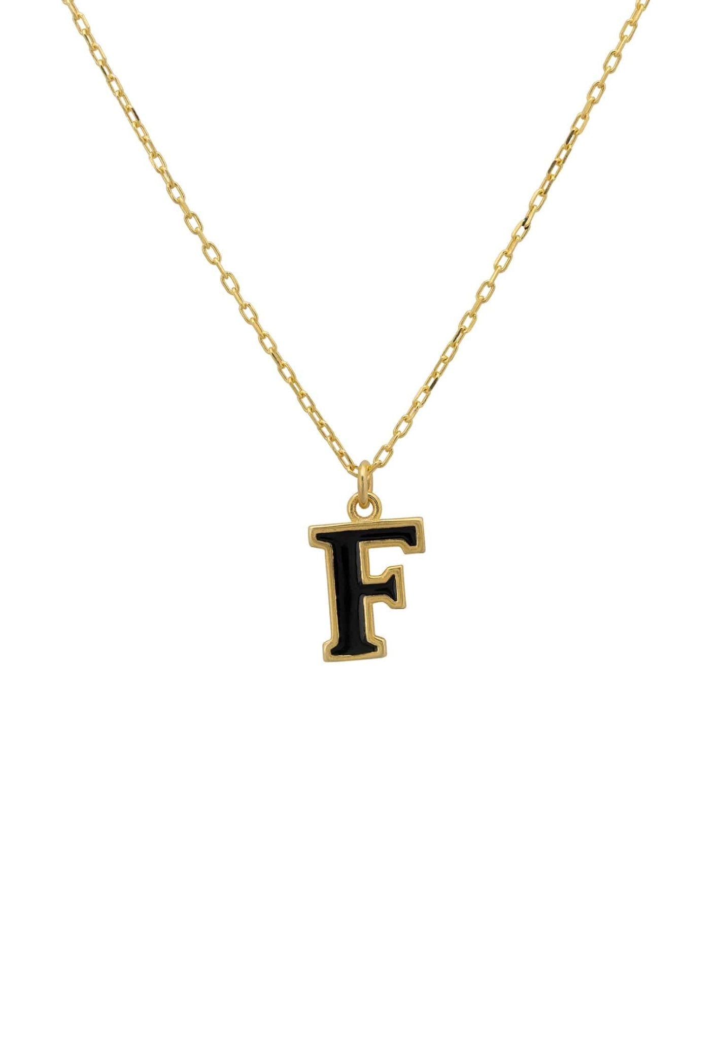 A delicate gold initial enamel necklace featuring a black enamel inlay, elegantly displayed in a signature jewellery box.