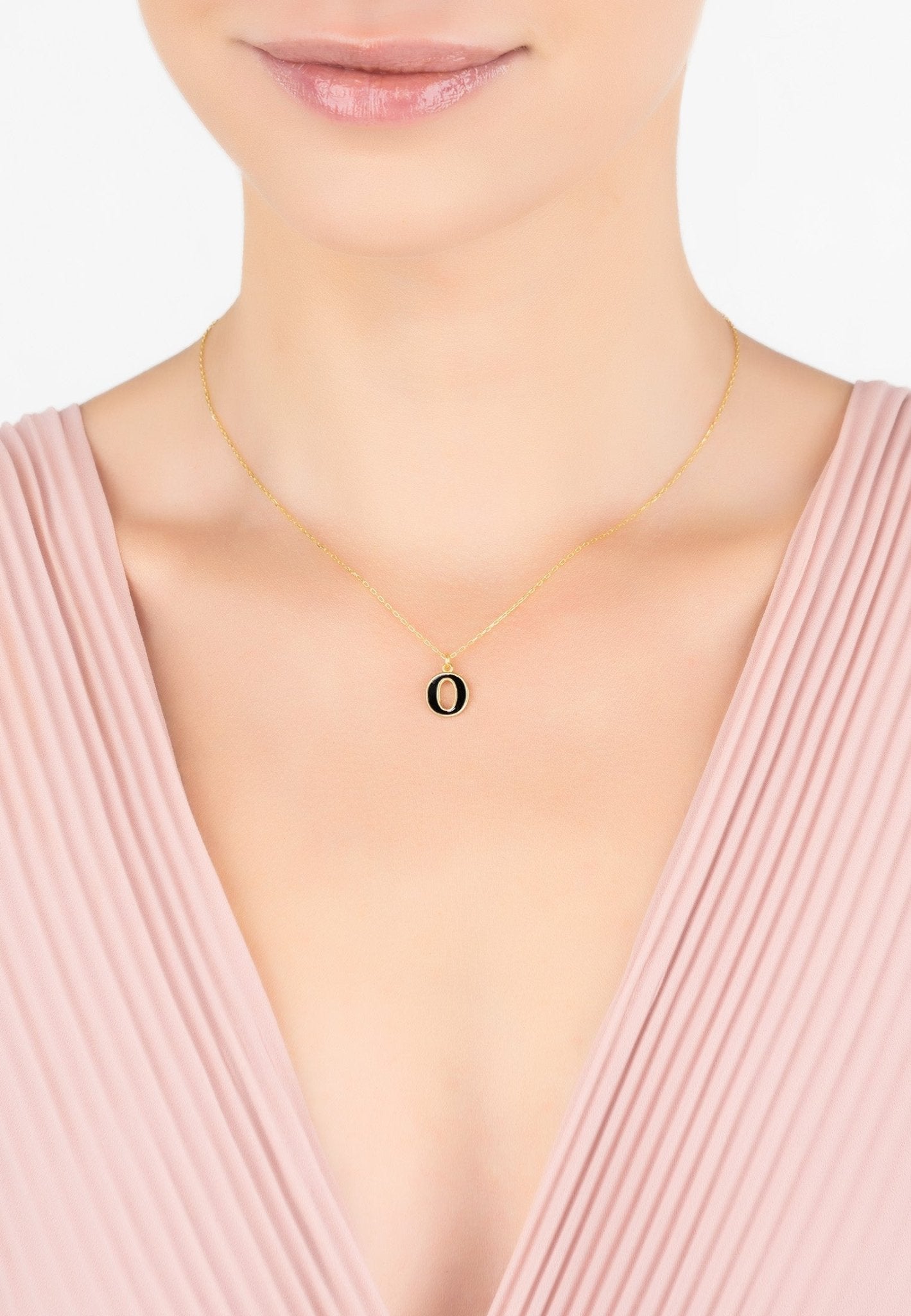 Gold Initial Enamel Necklace featuring a black enamel inlay, elegantly designed with a delicate chain.