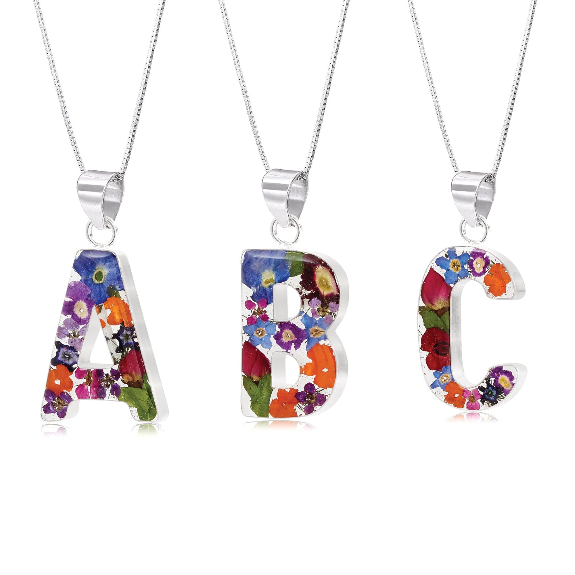 Handmade sterling silver initial necklace with real flowers, featuring an adjustable chain and stylish gift box.