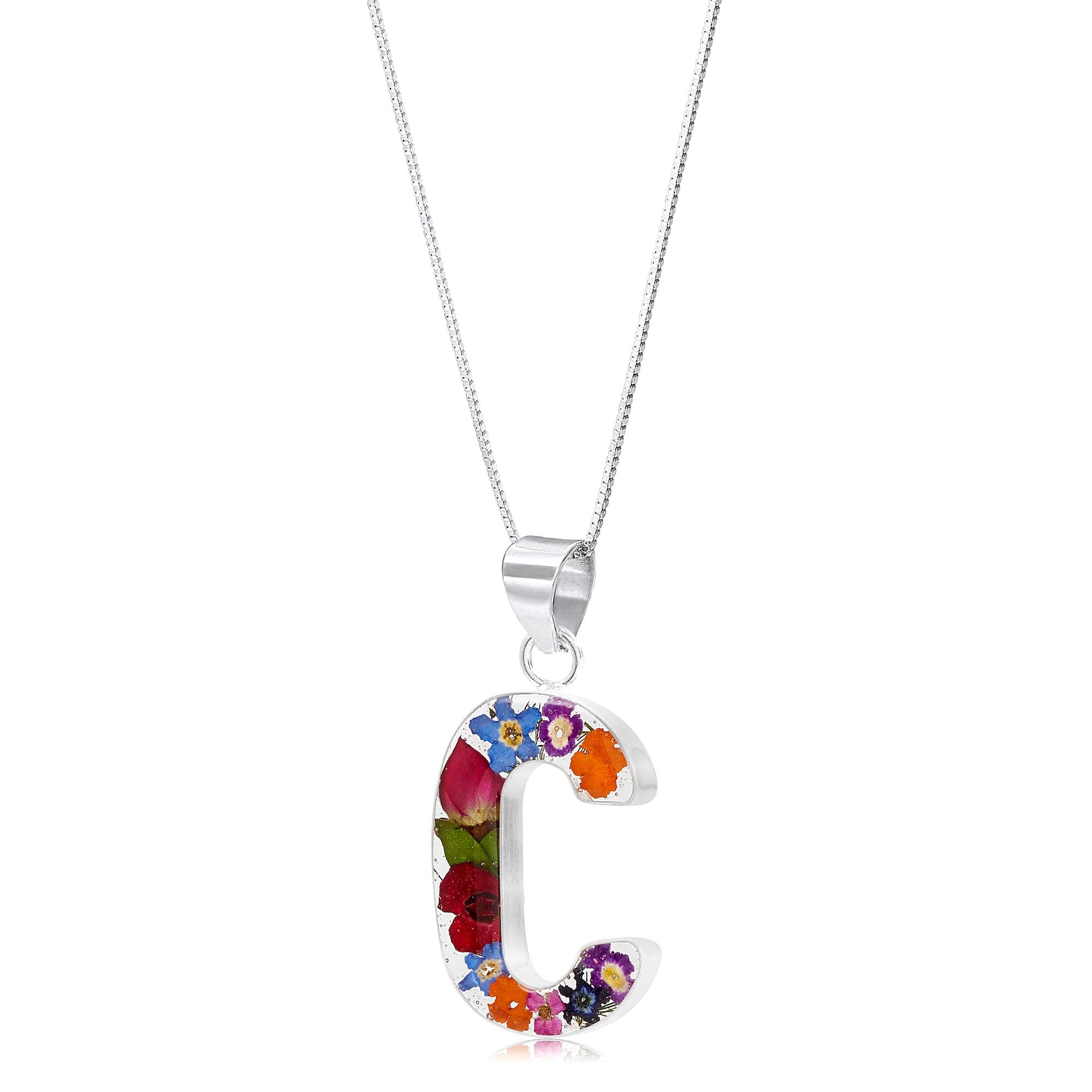 Handmade sterling silver initial necklace with real flowers, featuring an adjustable chain and stylish gift box.