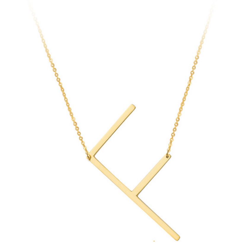 A large initial necklace featuring a polished gold tone finish, showcasing a customizable block letter design.