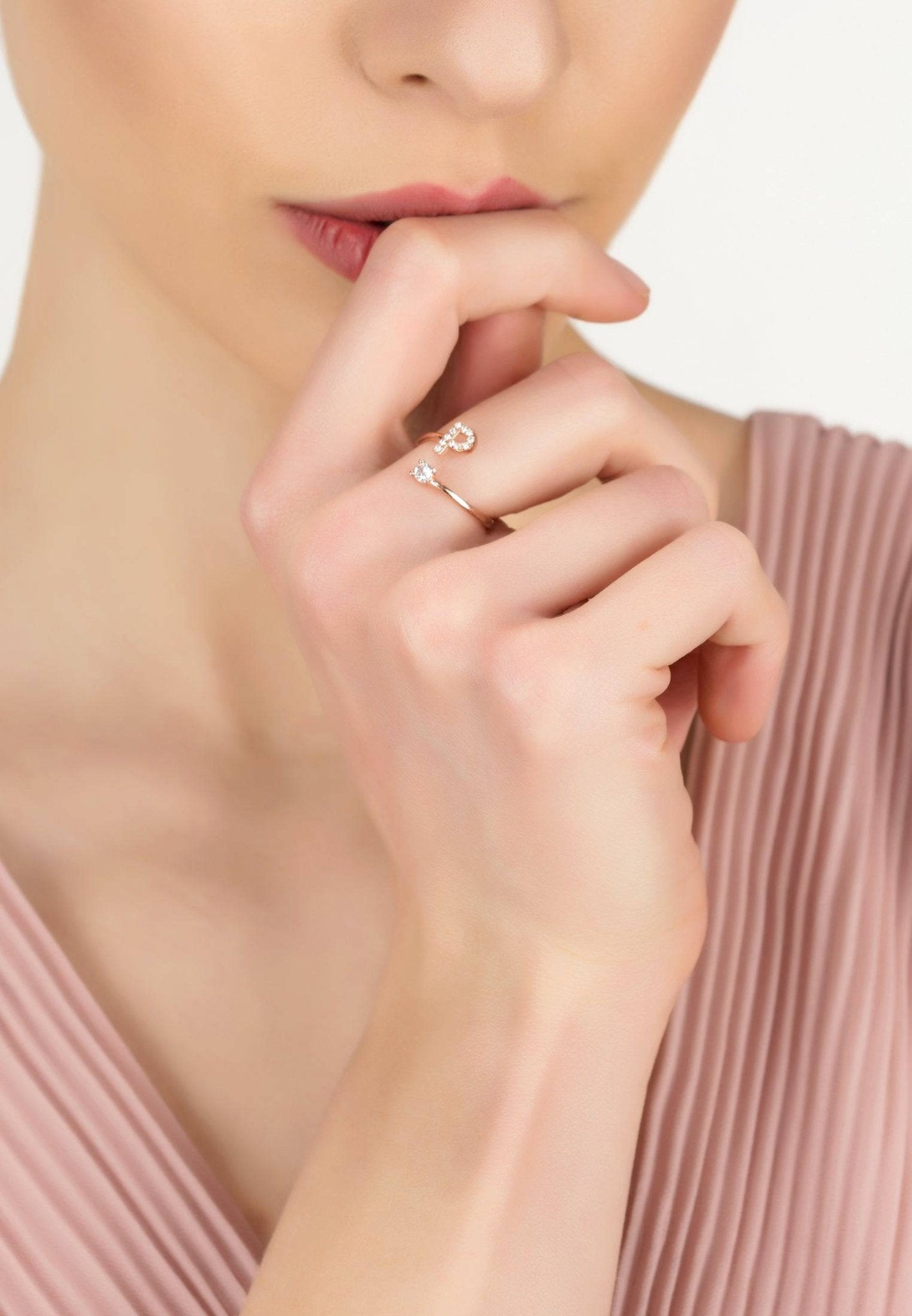 Initial Ring in Rosegold featuring a delicate design with cubic zirconia, handcrafted from sterling silver and dipped in 22ct rose gold.